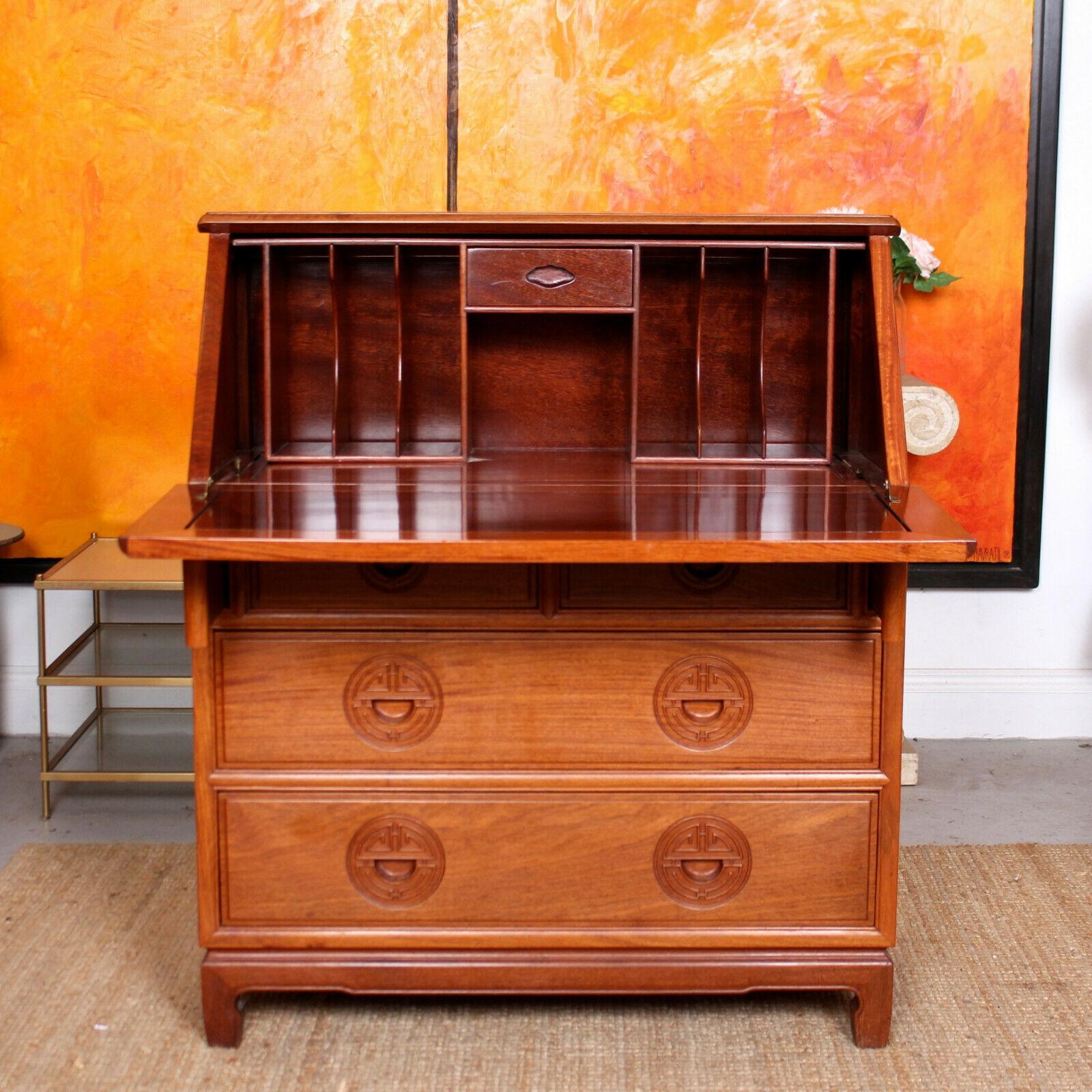 An impressive Oriental writing bureau.
The paneled top above a carved motif paneled fall flap enclosed fitted interior and miniature drawer. Fitted two short and two long graduated drawers below with carved inset handles, dovetailed jointing and