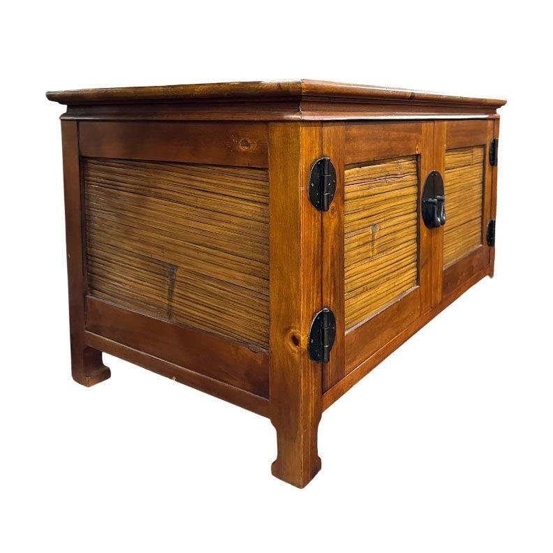 The Oriental Style reminiscent of designer James Mont with Koa Wood and Stick Rattan TV Console offers a blend of elegance and functionality. Crafted with fine wood and intricately woven rattan accents, it brings a touch of Eastern charm to any