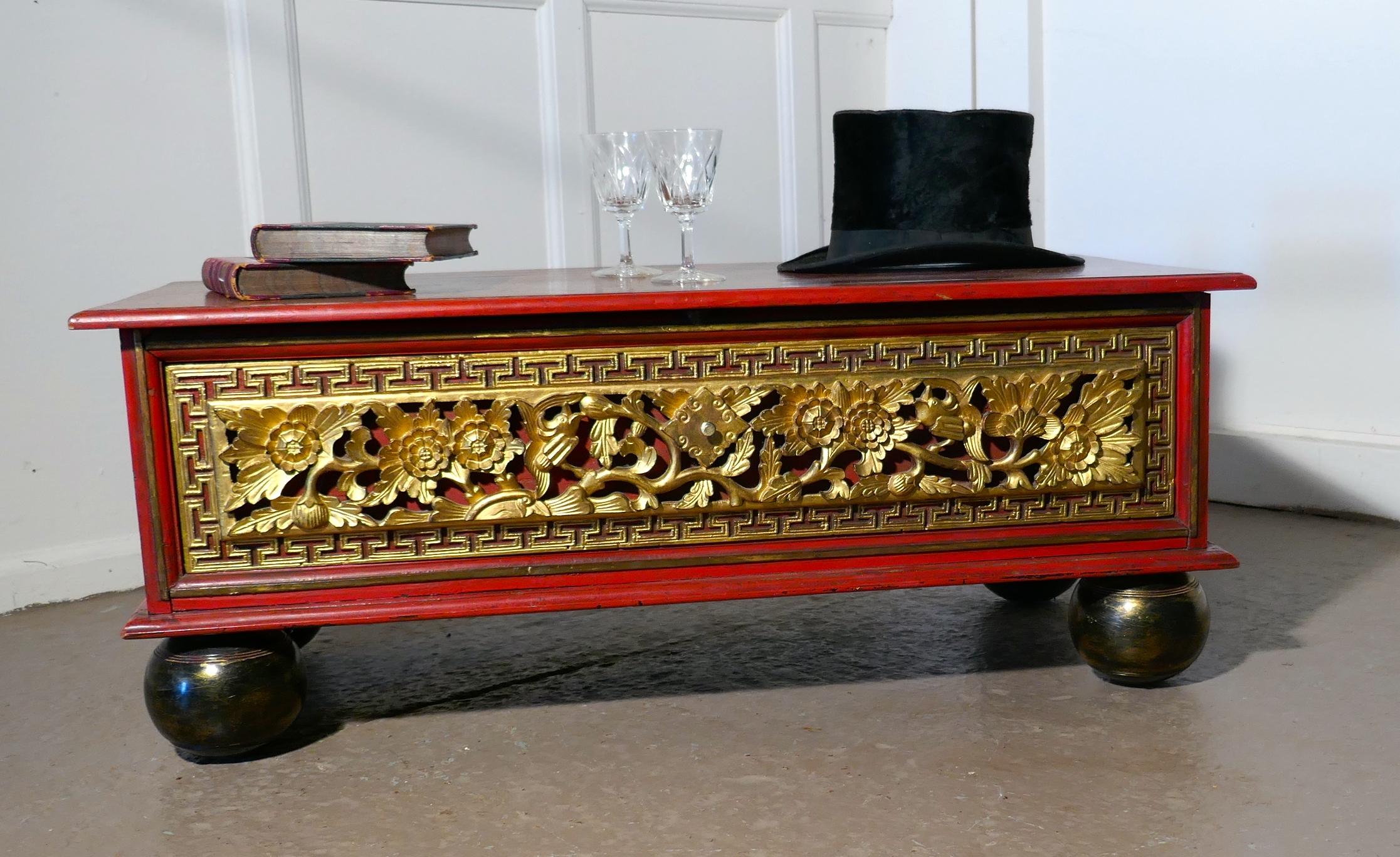 An oriental look low coffee table with drawer storage 

This is an unusual piece, the table is made in mahogany, it has a smooth well used top with a red painted trim to the borders, The table has a drawer, on the front of which there are deep