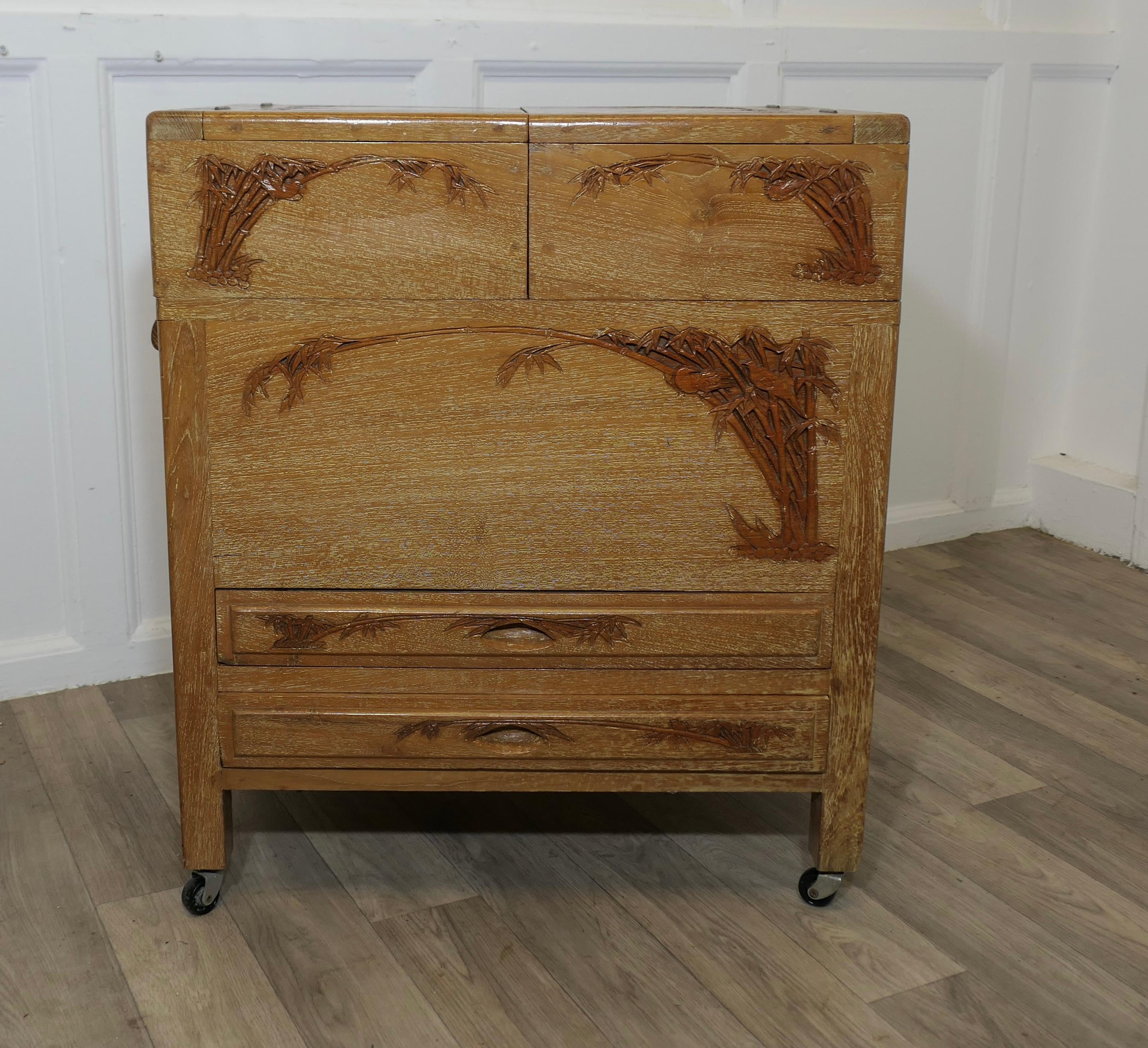 Oriental Metamorphic Concertina Sewing or Work Box 

Made in Golden Oak and very stylish, the wood is carved and dusted with liming polish it is decorated with bamboo and birds 
So much storage in such a small space, this great little piece opens