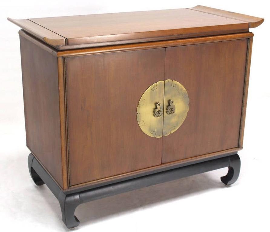 Quality mid-century modern walnut double doors bachelor chest cabinet dresser with beautiful brass hardware on black lacquer ebonised base. Gallery rolled edges top.