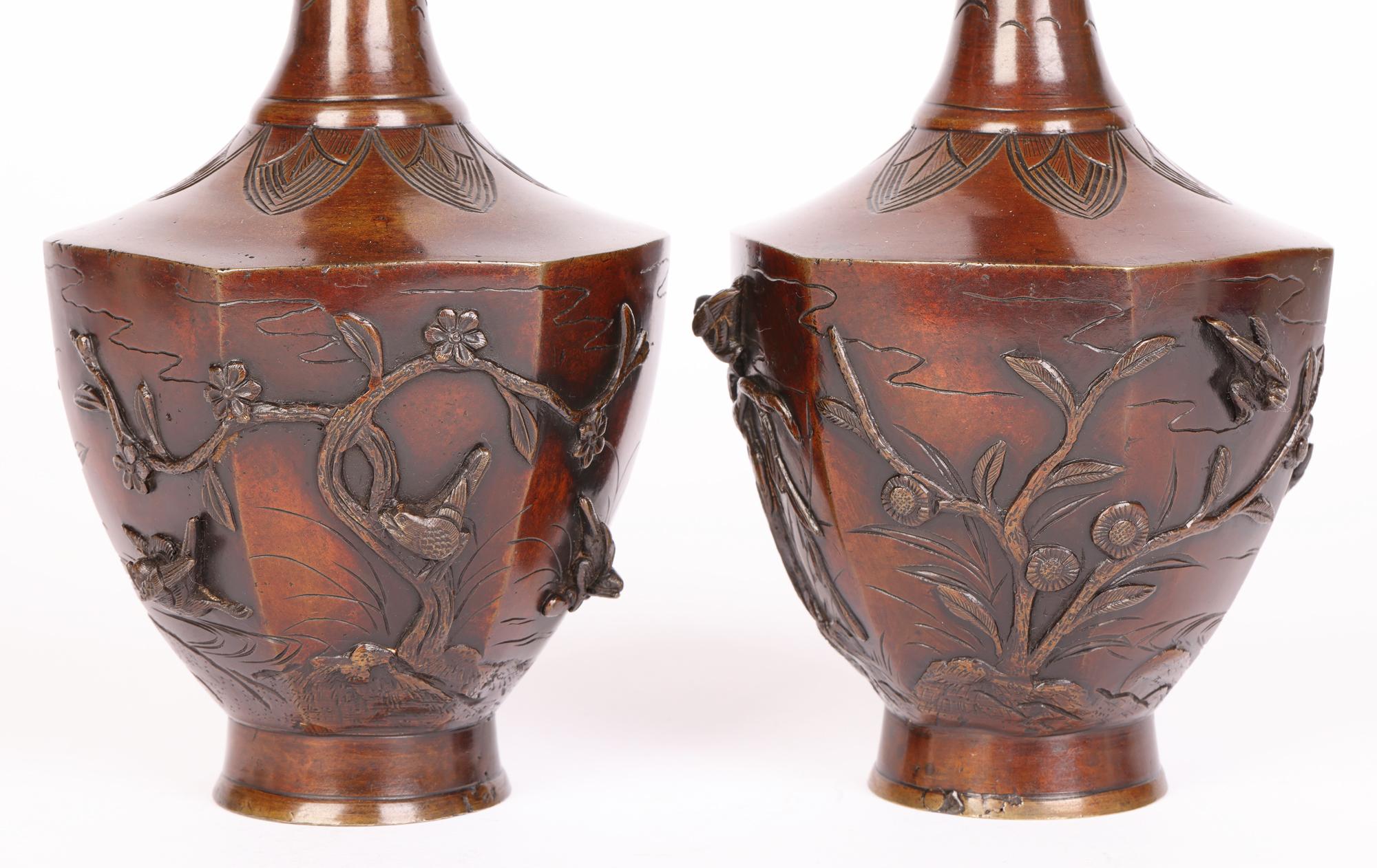 A very fine and stylish pair Oriental bronze vases, acquired as Chinese, applied with birds and dating from the latter 19th century. The vases stand on a narrow round pedestal foot with hexagonal shaped bodies and tall slender shaped necks. The