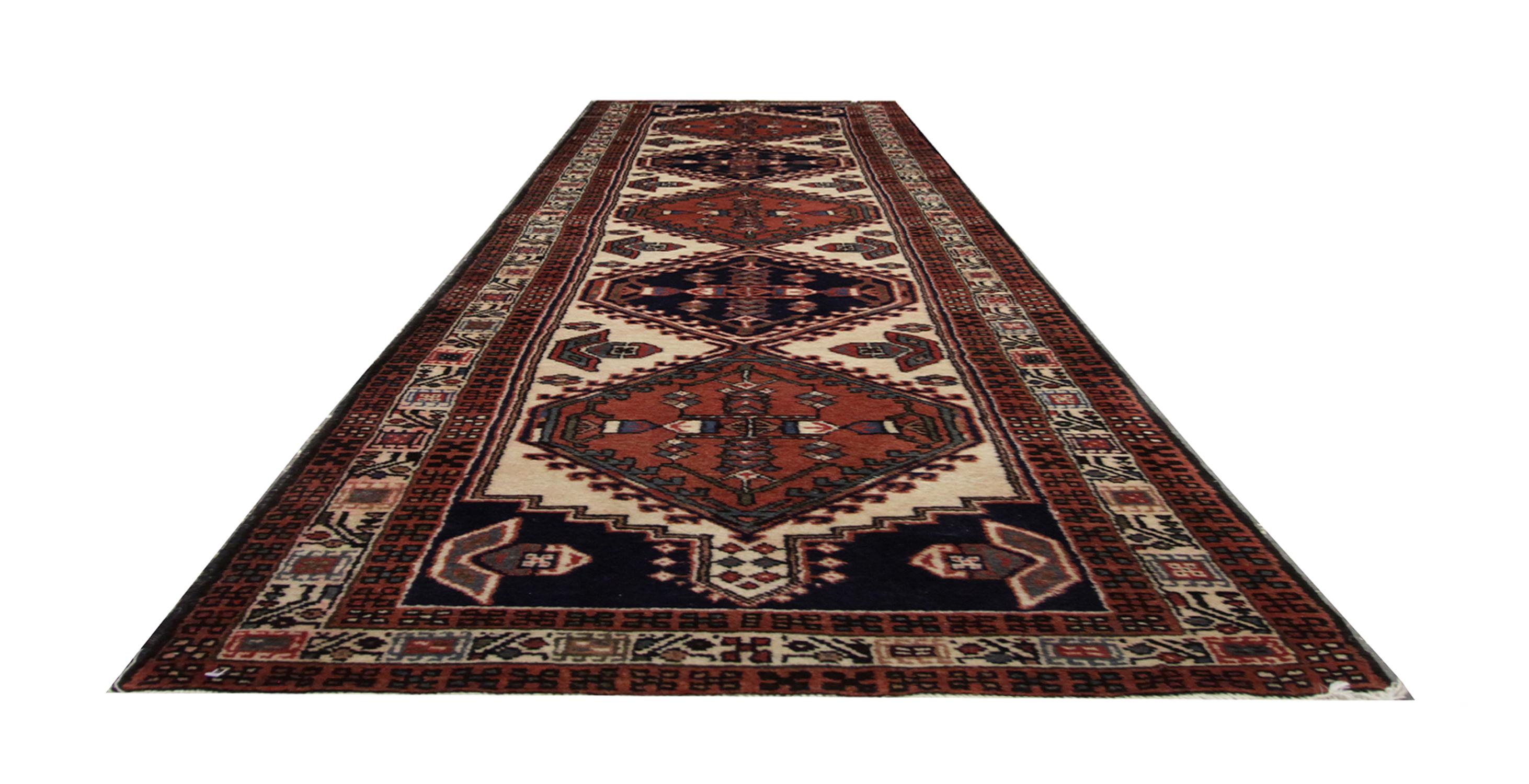 Handmade carpet Oriental rug muted tones sit in harmony in this brown / orange and cream Vintage runner rug. Constructed by hand by artisans in Pakistan this hallway runner features a detailed layered border and a central, blue and brown, repeat