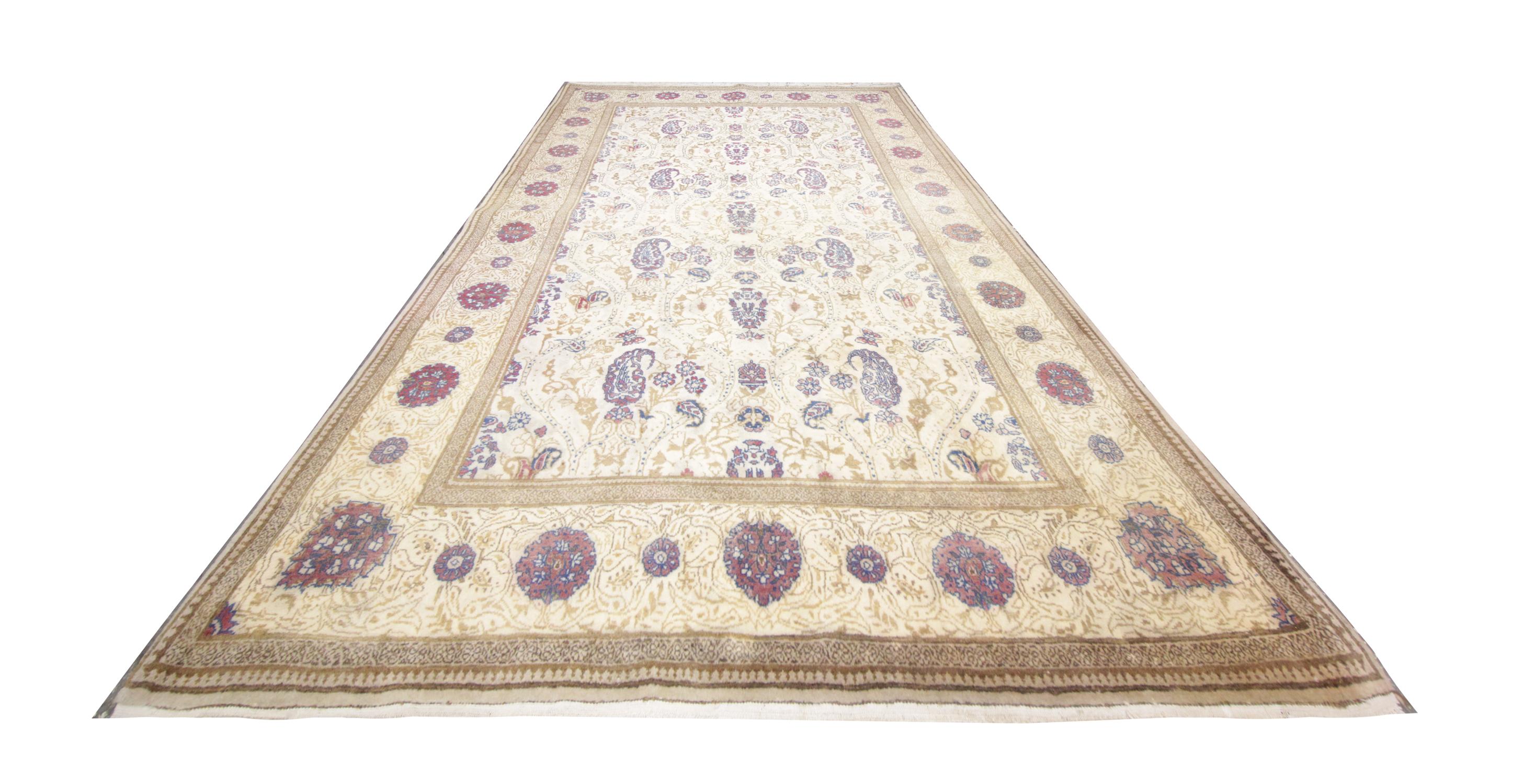 Beautifully handwoven patterns of floral and paisley designs sit on a background of cream and beige to create this stunning all-over design area rug. This vintage rug has been handmade carpet by Turkish artisans, created with handspun wool which has