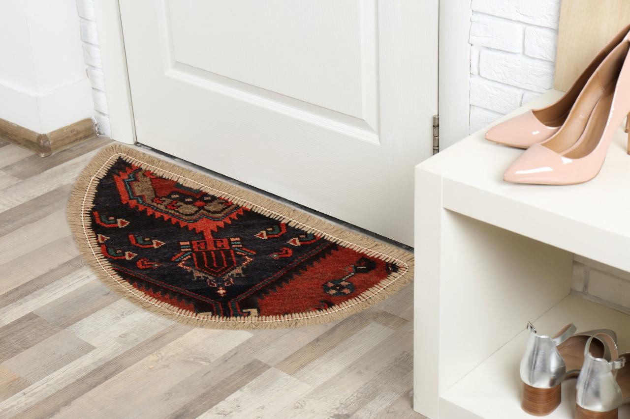 Oriental rug featuring a traditional floral pattern woven in deep rich tones this little mat is perfect for any doorway in tour modern or traditional home. This semicircle entranceway doormat has been refurbished from a handmade vintage rug- cut