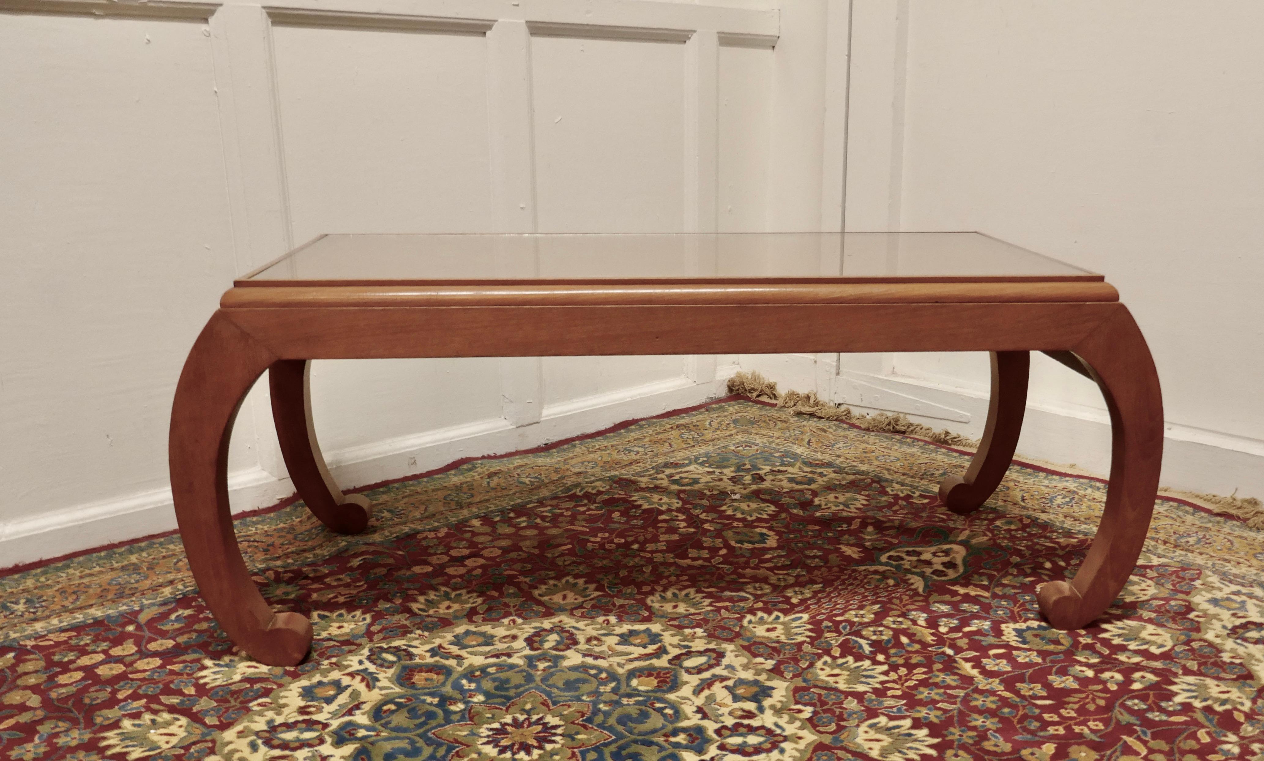 Oriental Satin walnut low table, coffee table

This is a very attractive piece, the table is in the style of an opium table, it has a carved border beneath the plate glass top
The table has an inset plate glass top which protects the the top when