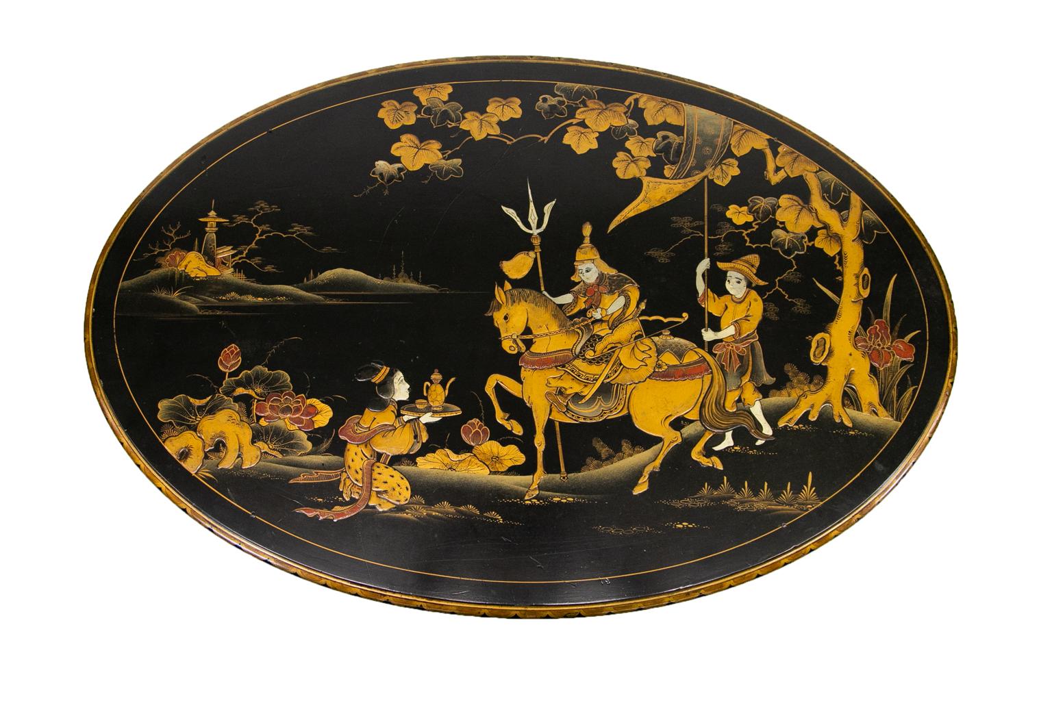 Oriental style English lacquer coffee table, the top decorated with mountains and a mountain warrior 
followed by an attendant and being offered a beverage by a kneeling woman. The aprons are decorated with floral arabesques and quilted panels over