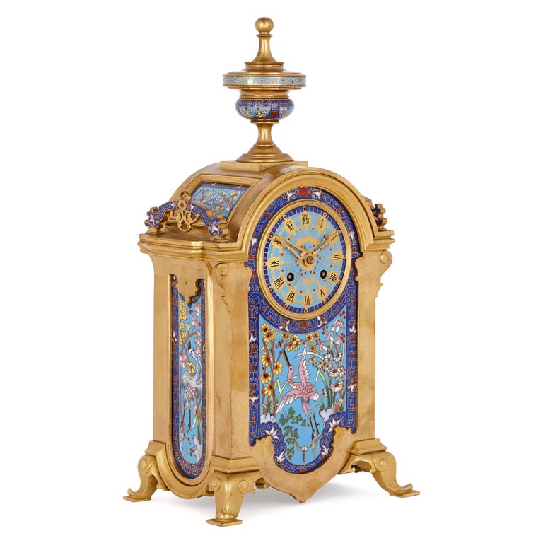 This clock set was designed in France in the late 19th century in a fanciful ‘Oriental’ style. The set is comprised of a mantel clock and a pair of candelabra, all of which have been crafted from gilt bronze (ormolu) and ornately decorated with