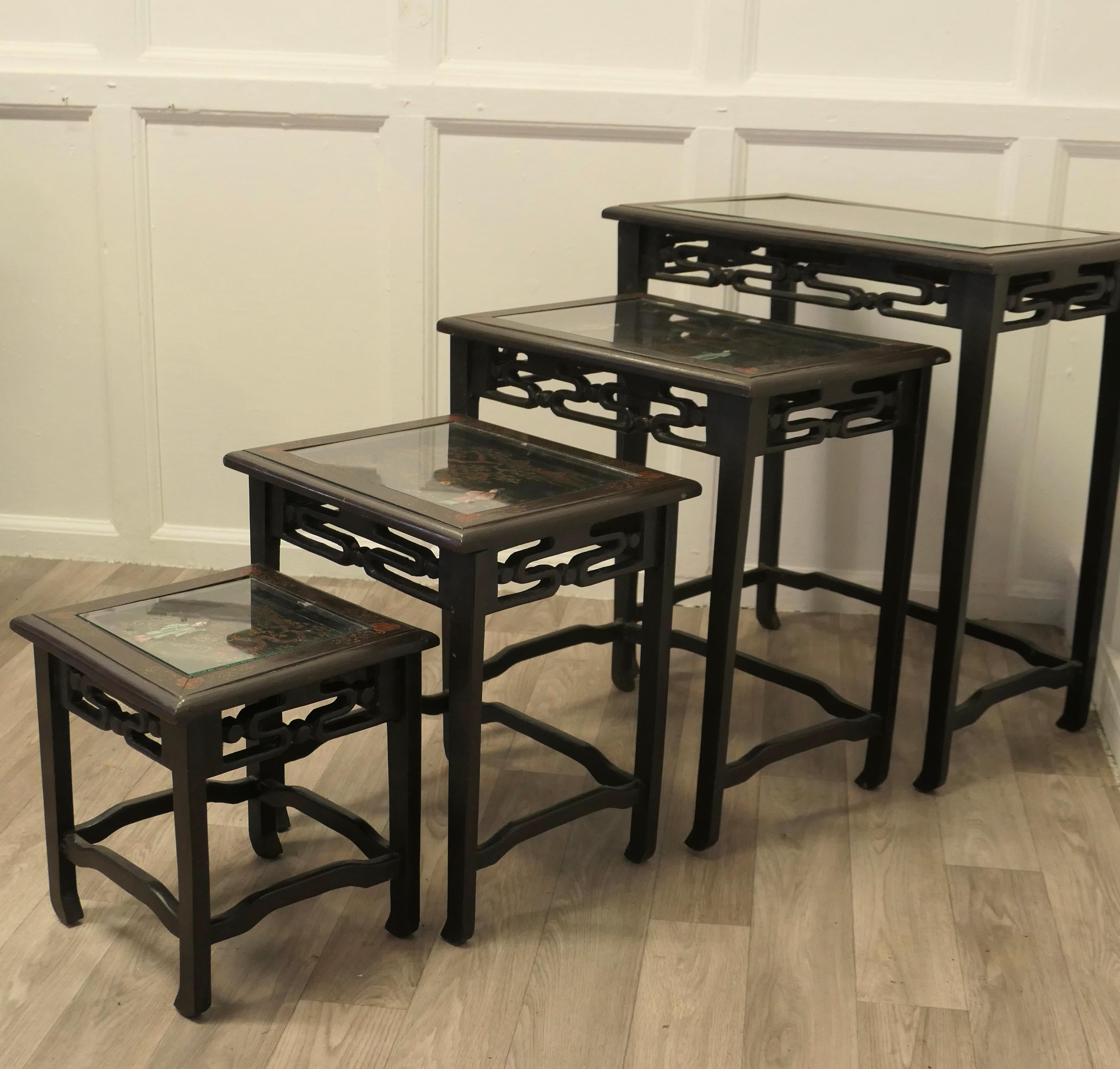 Oriental Style Nest of 4 Tall Lacquer Tables  

This is an impressive set of tables, the nest has 4 tall Chinoiserie lacquer tables, the tables are sound and in good condition, they have inset glass tops to protect the decoration.
The Table tops