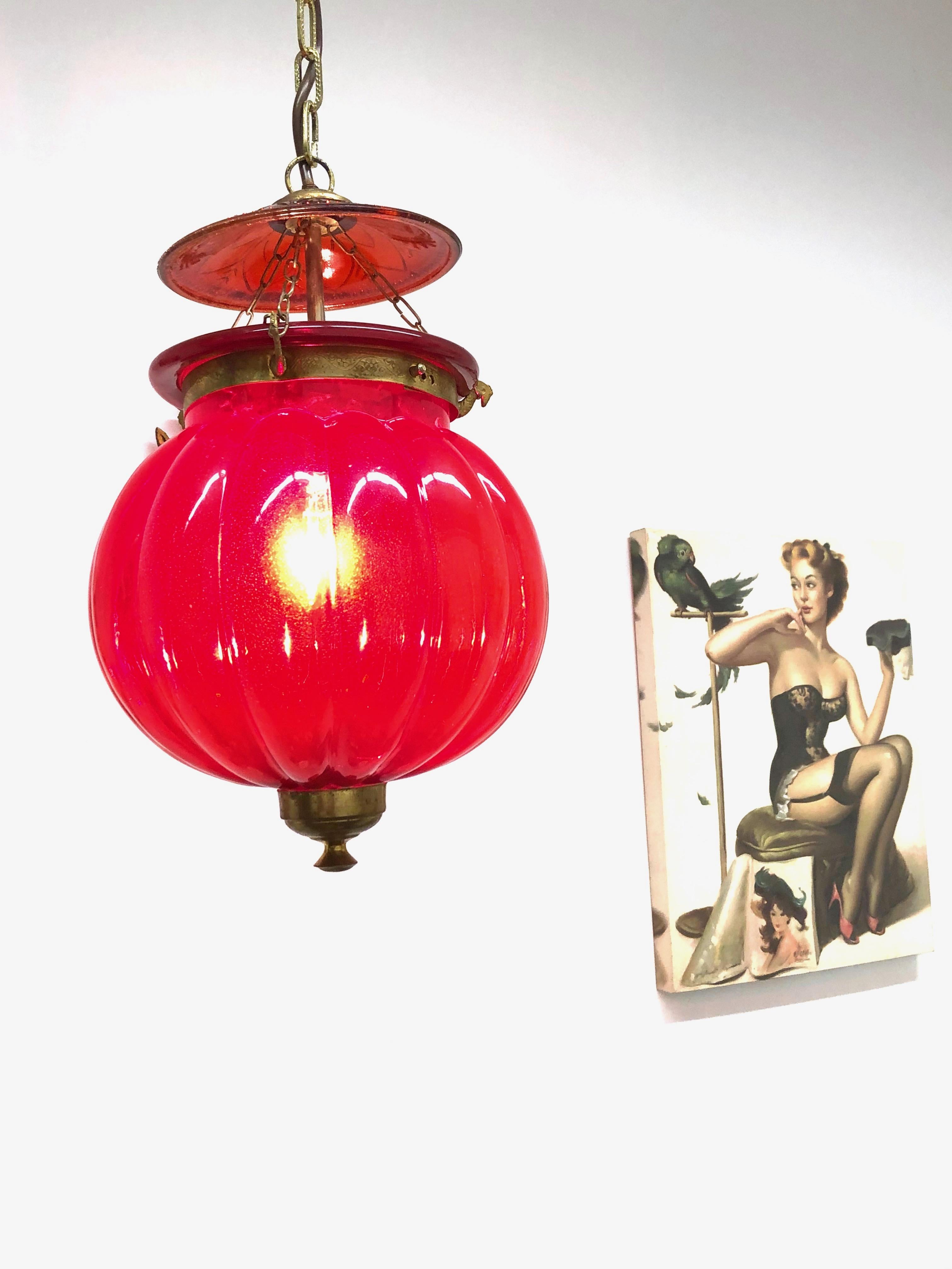 Beautiful oriental style red glass and brass Hall Lantern Pendant. Nice addition to every home or House. This light fixture remains in very good vintage condition with wear to the glass and some patina to the brass frame. The Fixture requires one