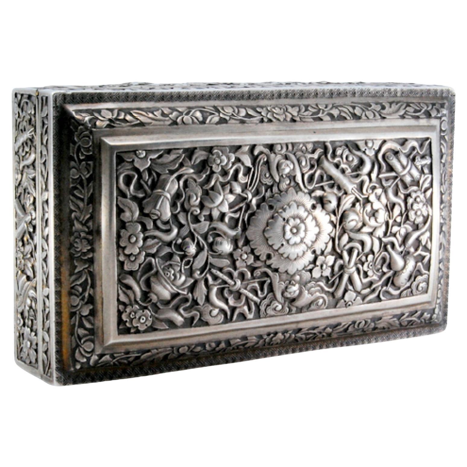 Description: Silver jewelry box in Oriental style with raised plant motifs on the casing and hinged lid. Metal: Silver. Origin: Oriental. Mark: Absent. Weight: 329.55 grams. Dimensions: 12.8x7.5cm. Content: 925/1000. Assay Mark: Absent. Additional