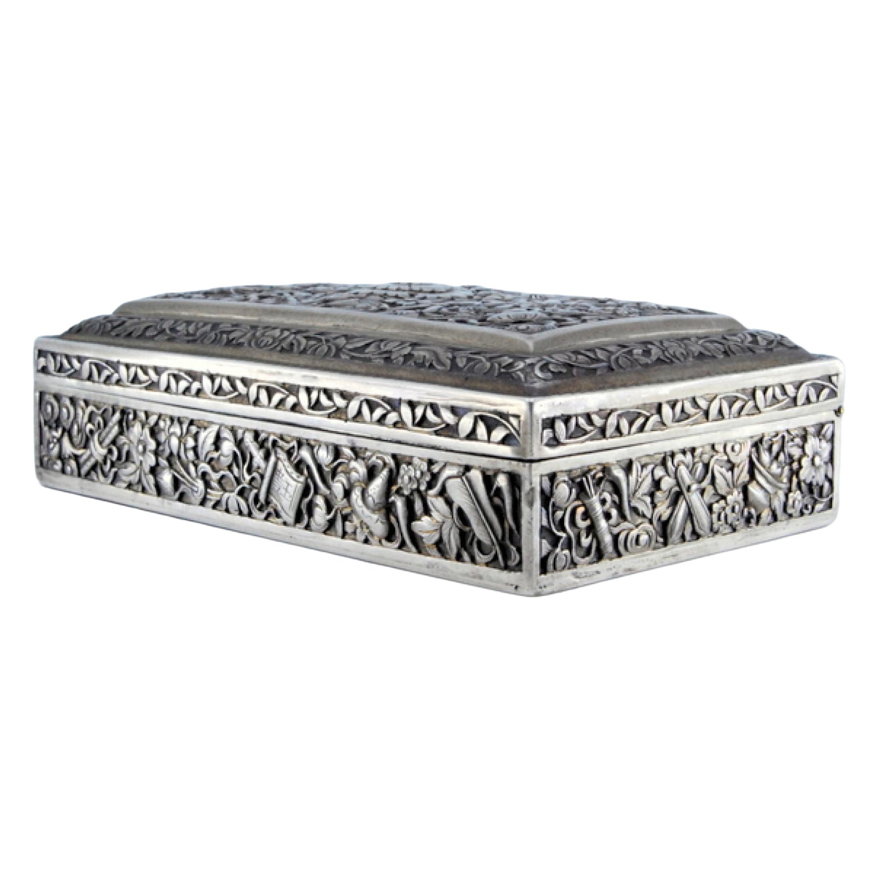 Oriental-style silver jewelry box with raised plant motifs and hinge