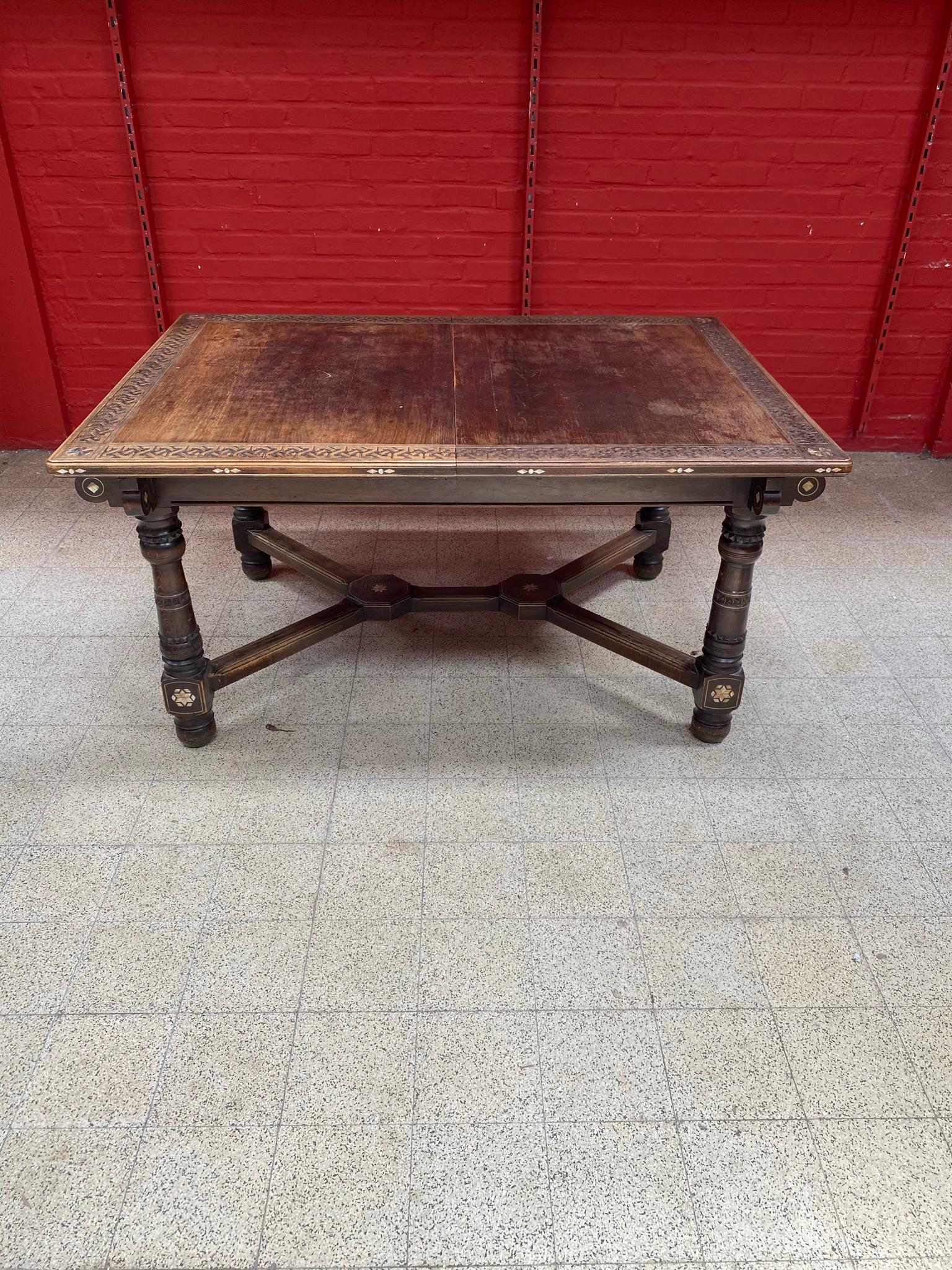 Oriental-style table in wood and carved wood, with mother-of-pearl inlay; 
small losses of mother-of-pearl.
Provenance the Old Palace Saint George in Alger, circa 1880.
Is part of a complete dining room.