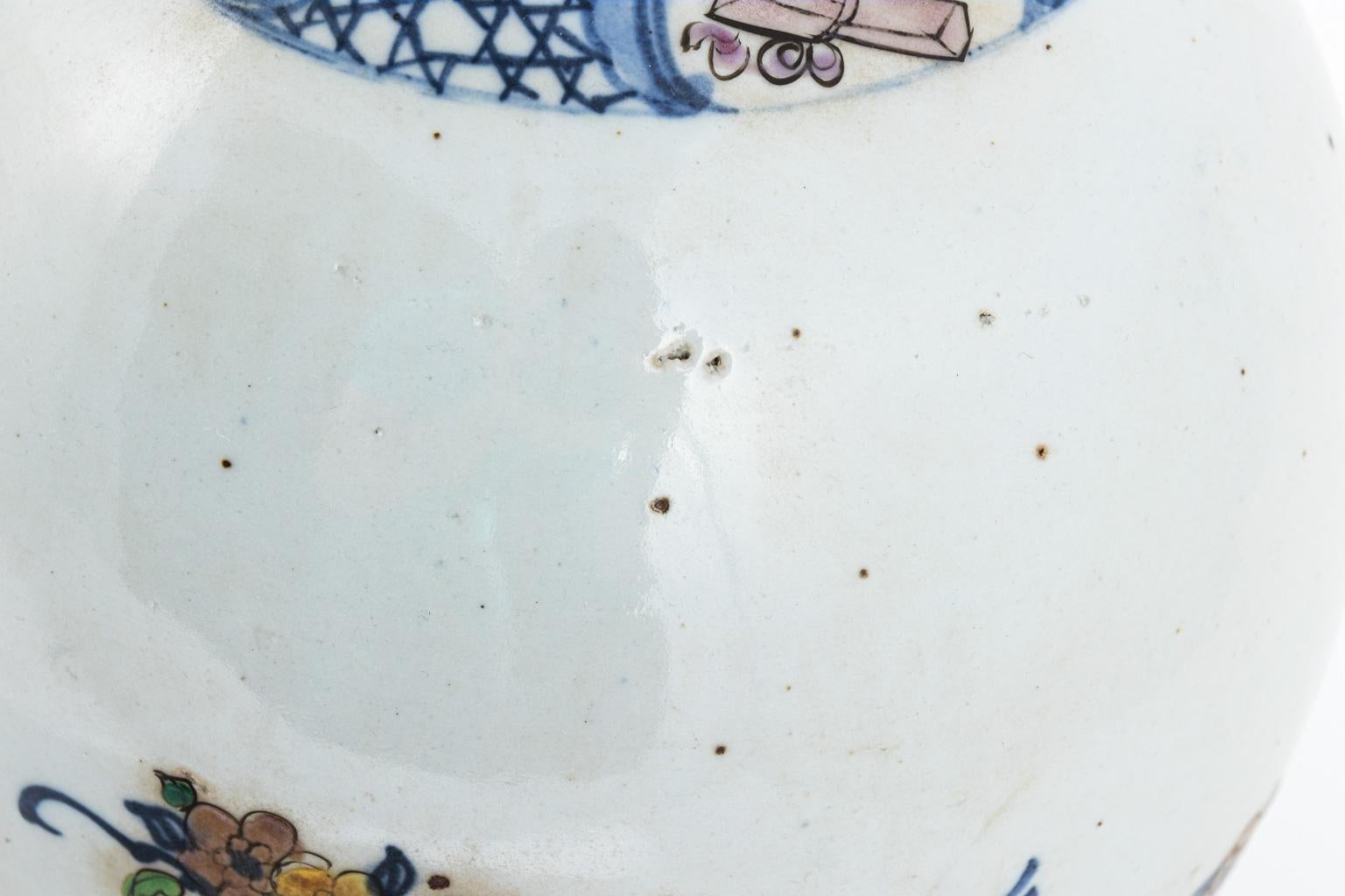 Painted vase with Elephant handles that features details of flowers and birds, circa 20th century. Please note of wear consistent with age including chips, discoloration, and pitting in the ceramic.
 