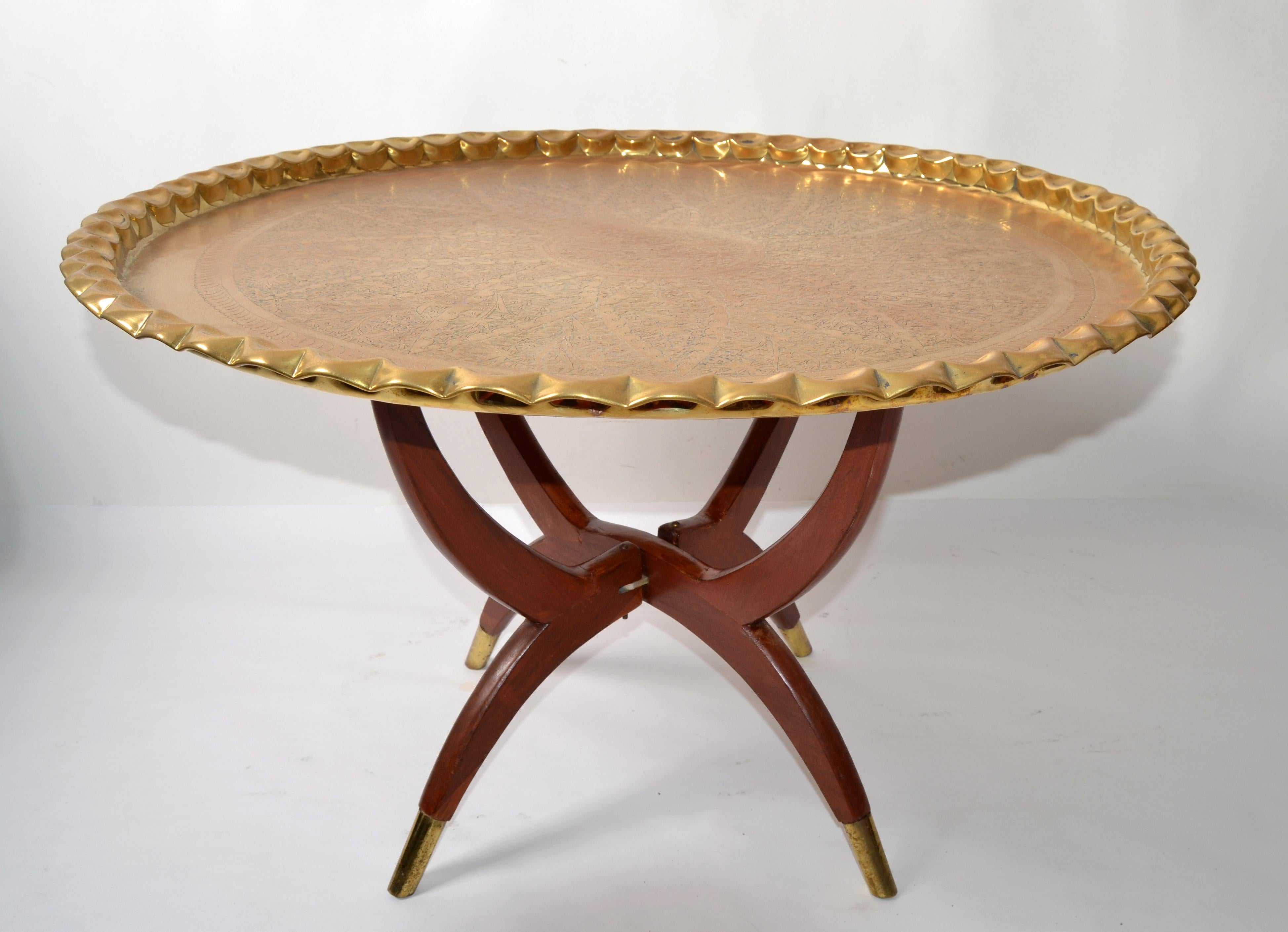 Oriental Vintage Mid-Century Modern walnut spider leg round coffee table with a Moroccan bronze scalloped design tray.
The base folds up for easy storage and the feet tips will be accented in brass.
No markings.
Base measures: 20 x 20 x 18 inches