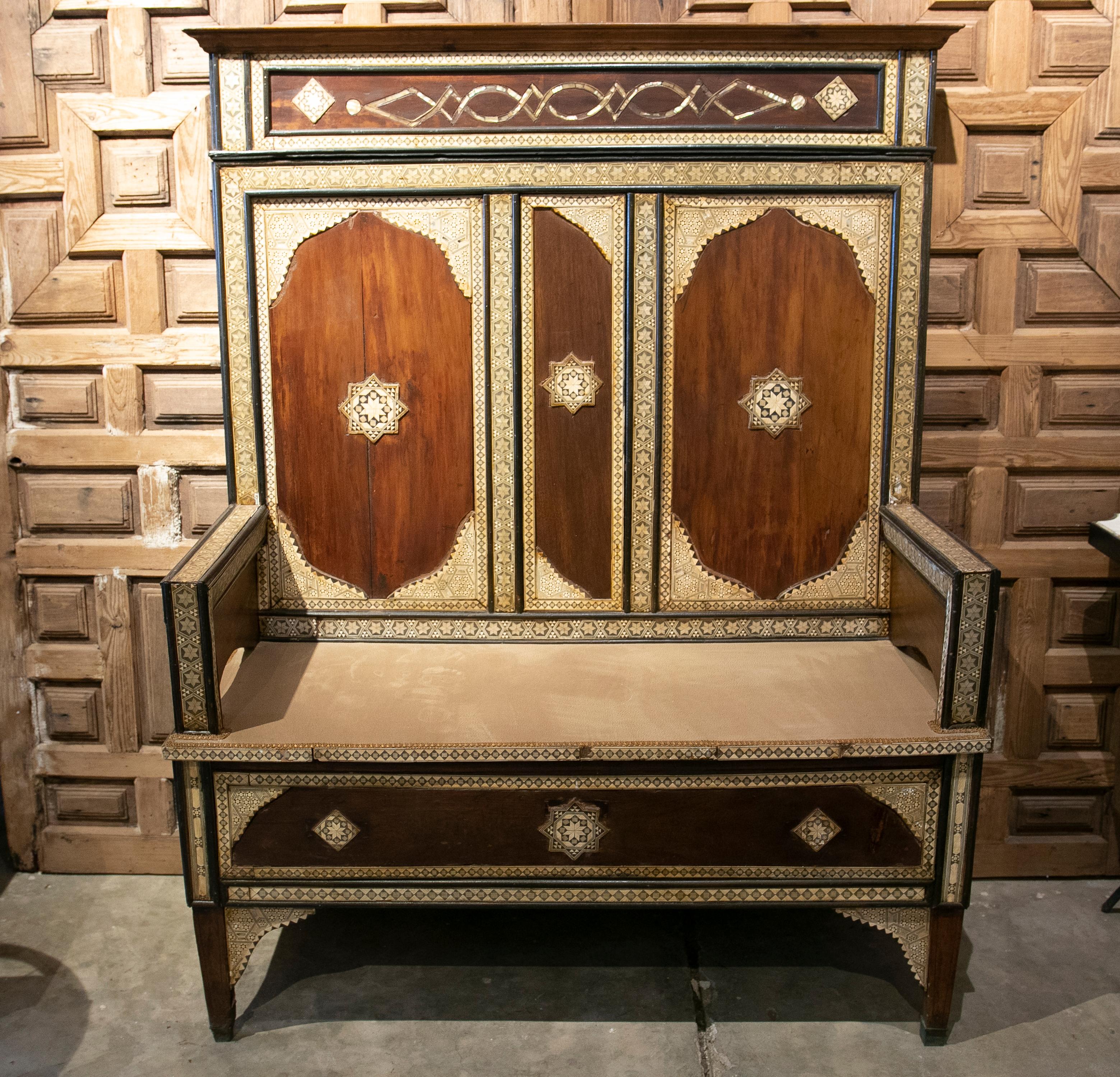 Oriental wooden bench with high backrest and inlays.