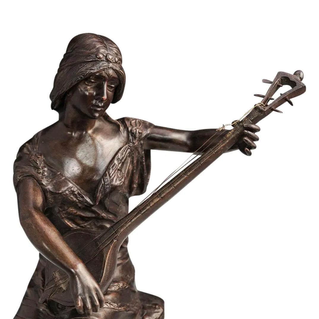 Female mandolin player, Joueuse de Mandoline, after the French sculptor, Couderc, active late 19th to early 20th century.