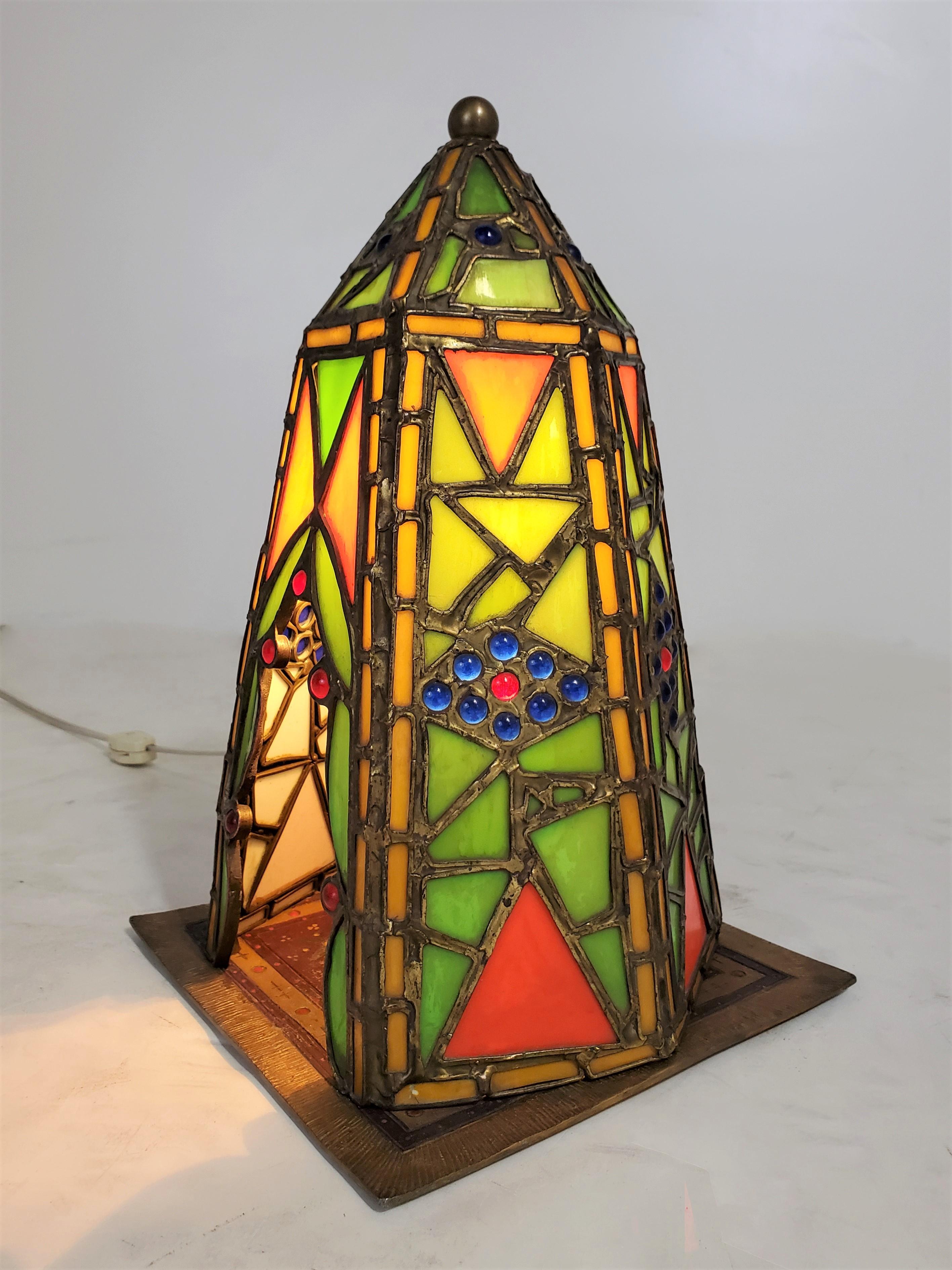 A charming Middle Eastern theme decorative table lamp / night light in leaded glass and cold painted French metal. Highly atmospheric with a soft glow and deep rich colors, the mosaic like tent illuminates to display a musician playing a mandolin