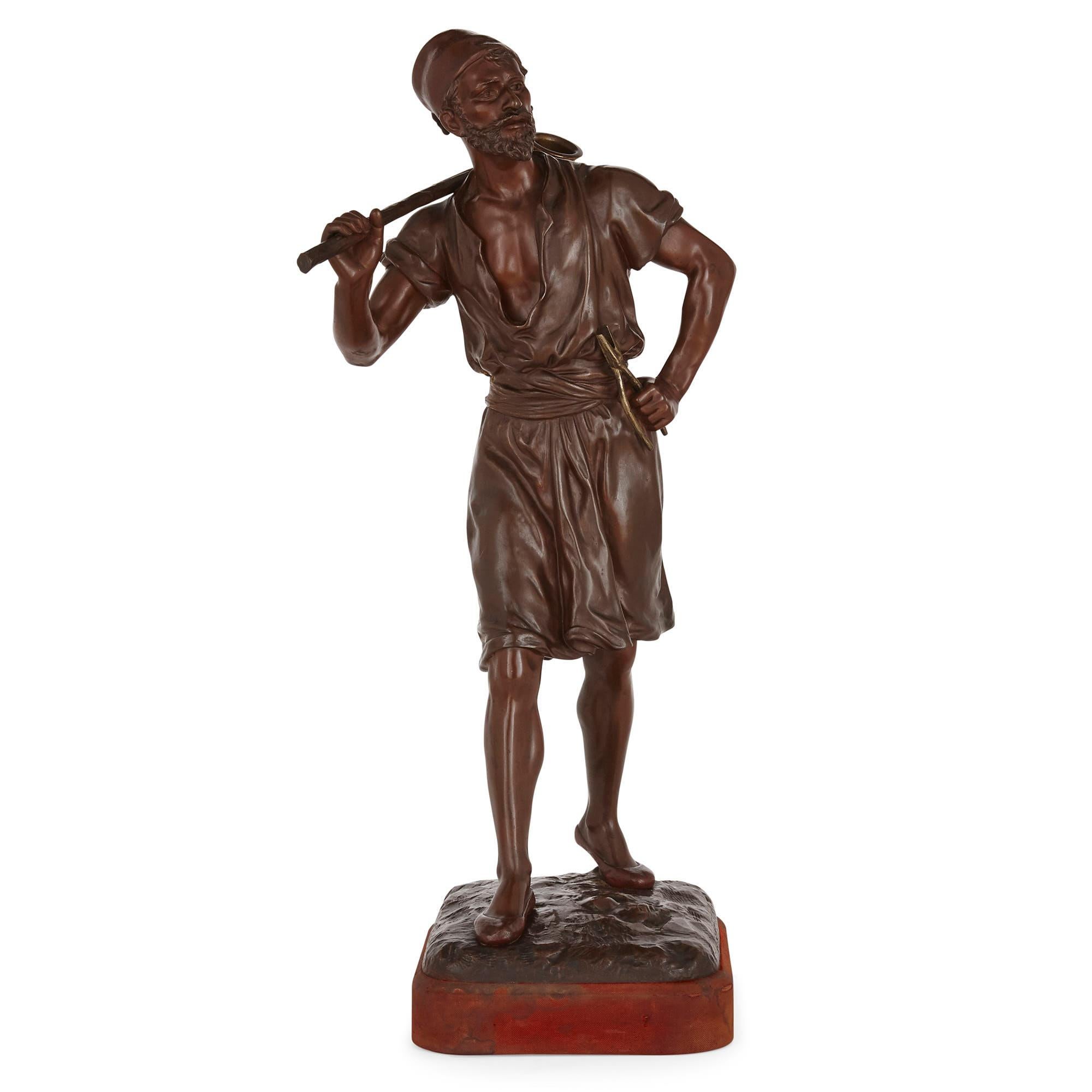 This large bronze figure was sculpted by the French artist Marcel Debut and cast by the Oudin foundry in Marseille (‘Debut’ and ‘Oudin’ are signed to the base).

The figure represents a walking male figure who holds a bindle over his shoulder,