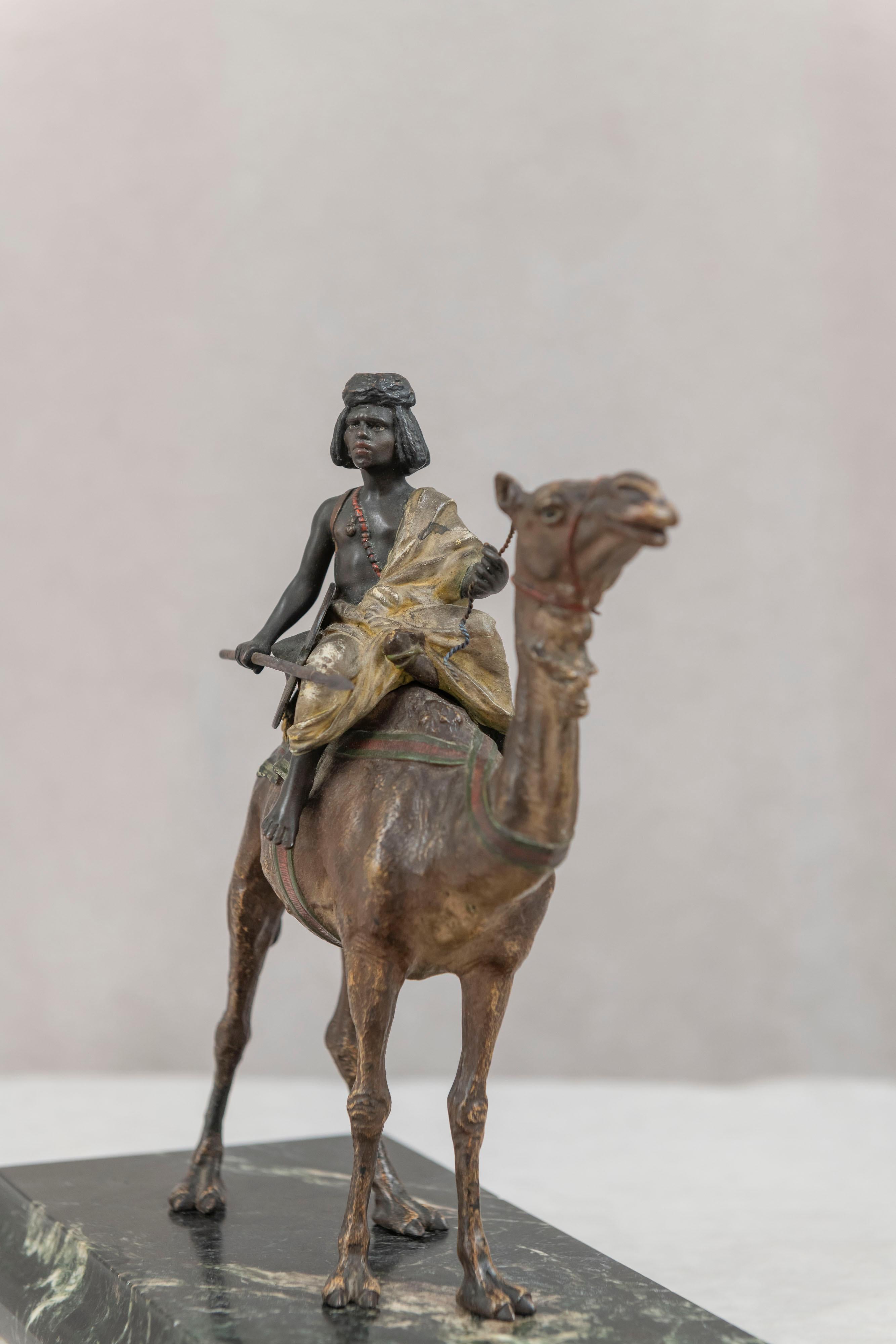 This Orientalist bronze was done by Franz Bergman and does bear his signature. Meticulously cold painted and highly detailed make this one of his best examples. The camel and the boy are truly realistic. Securely mounted on a rich green marble base,