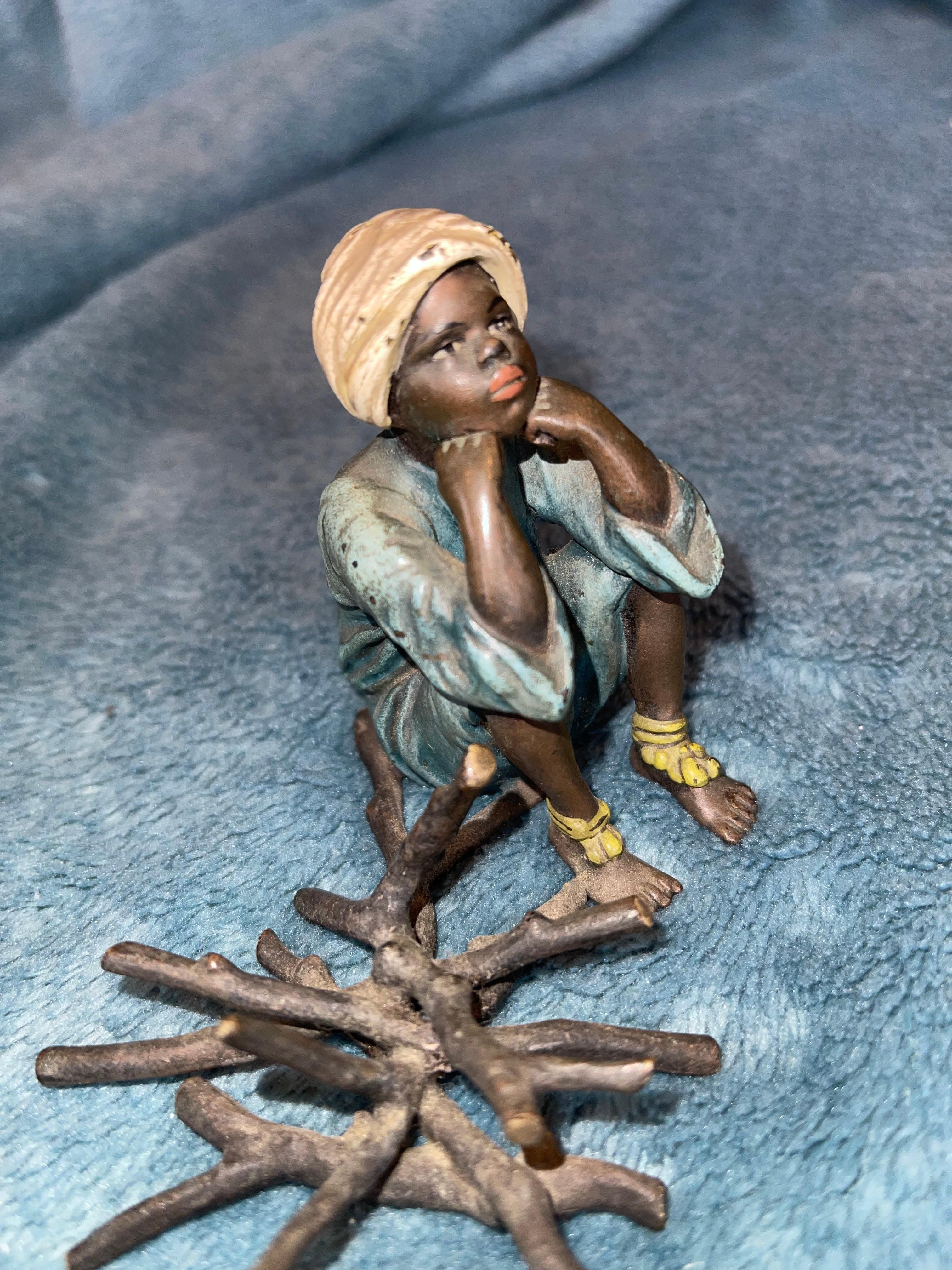 Austrian Orientalist  Cold Painted Vienna Bronze Young Boy Seated Near Fire Logs, Signed For Sale