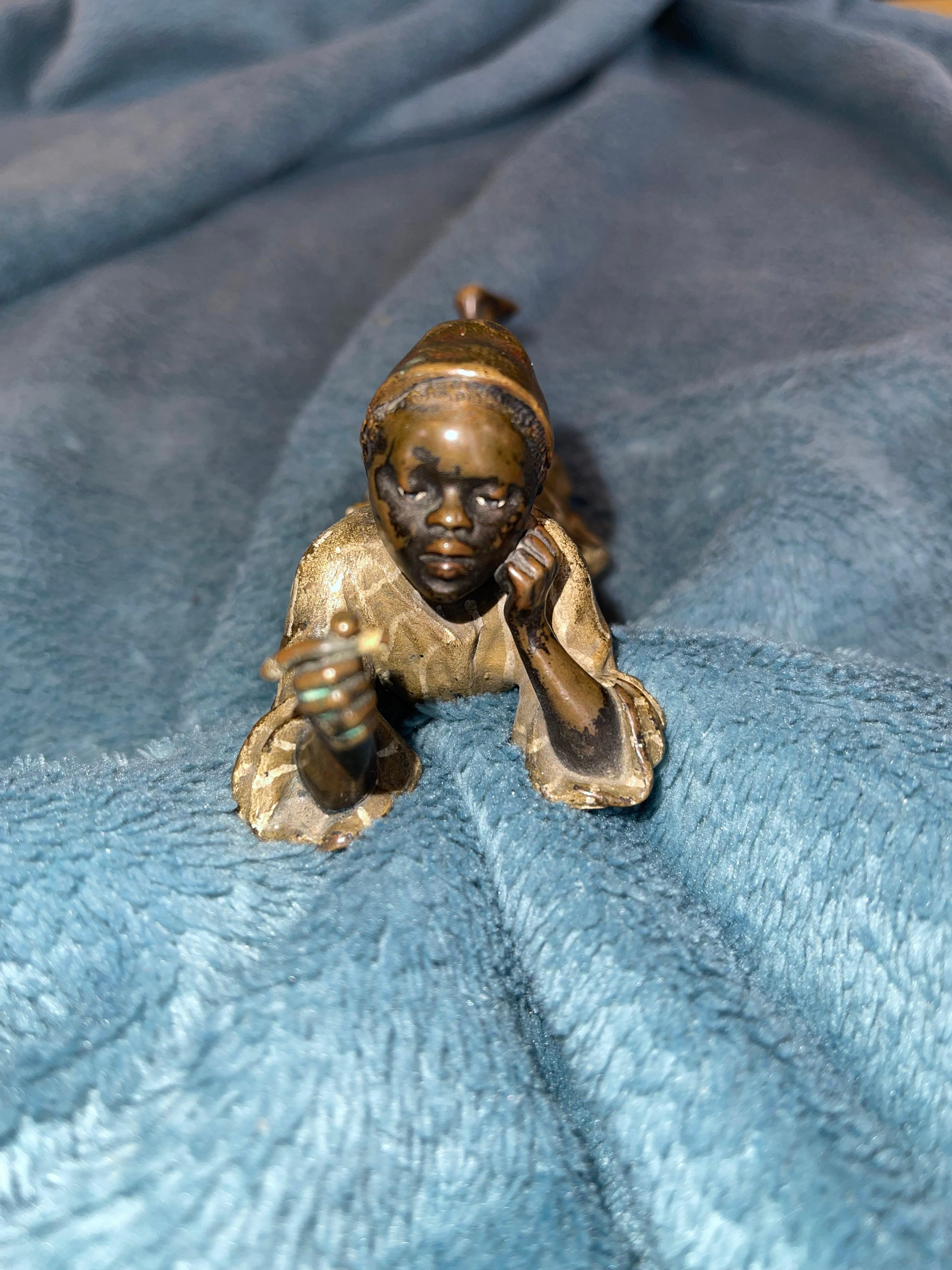 Cast Orientalist  Cold Painted Vienna Bronze Young Boy Seated Near Fire Logs, Signed For Sale