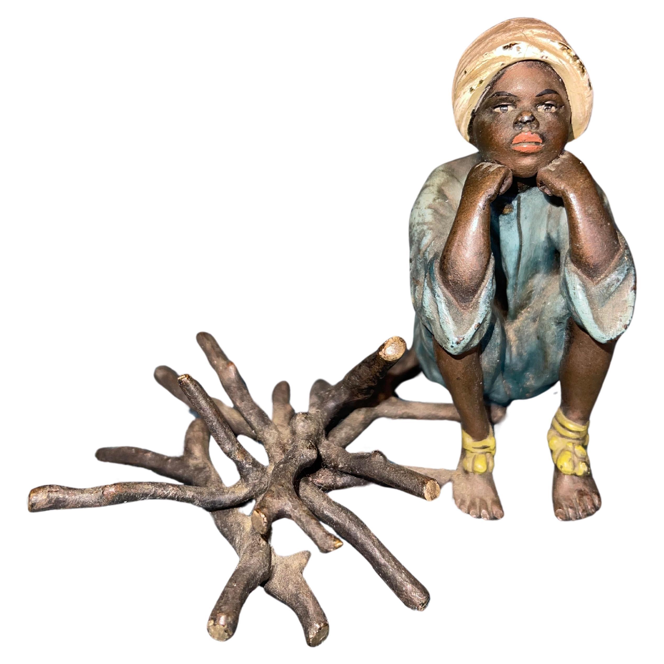 Orientalist  Cold Painted Vienna Bronze Young Boy Seated Near Fire Logs, Signed For Sale