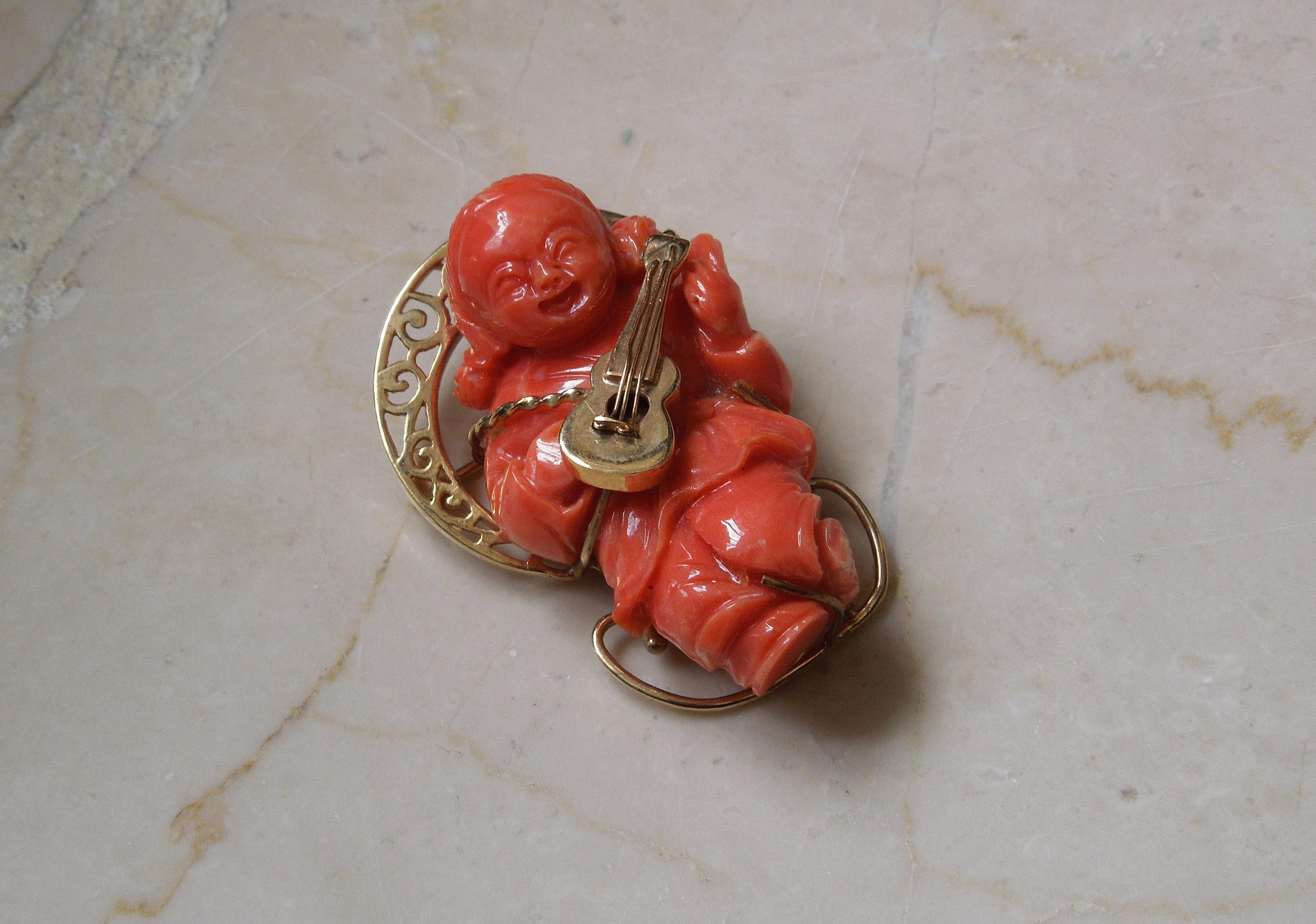 Featuring 1 Single Hand Carved piece of Natural Coral, secured in 3 Gold Prongs as well as reinforced by musical instrument - Hand-Fabricated completely of 14 Karat Gold. With a vivid, even color, Coral / Red Coral of this fine quality is becoming