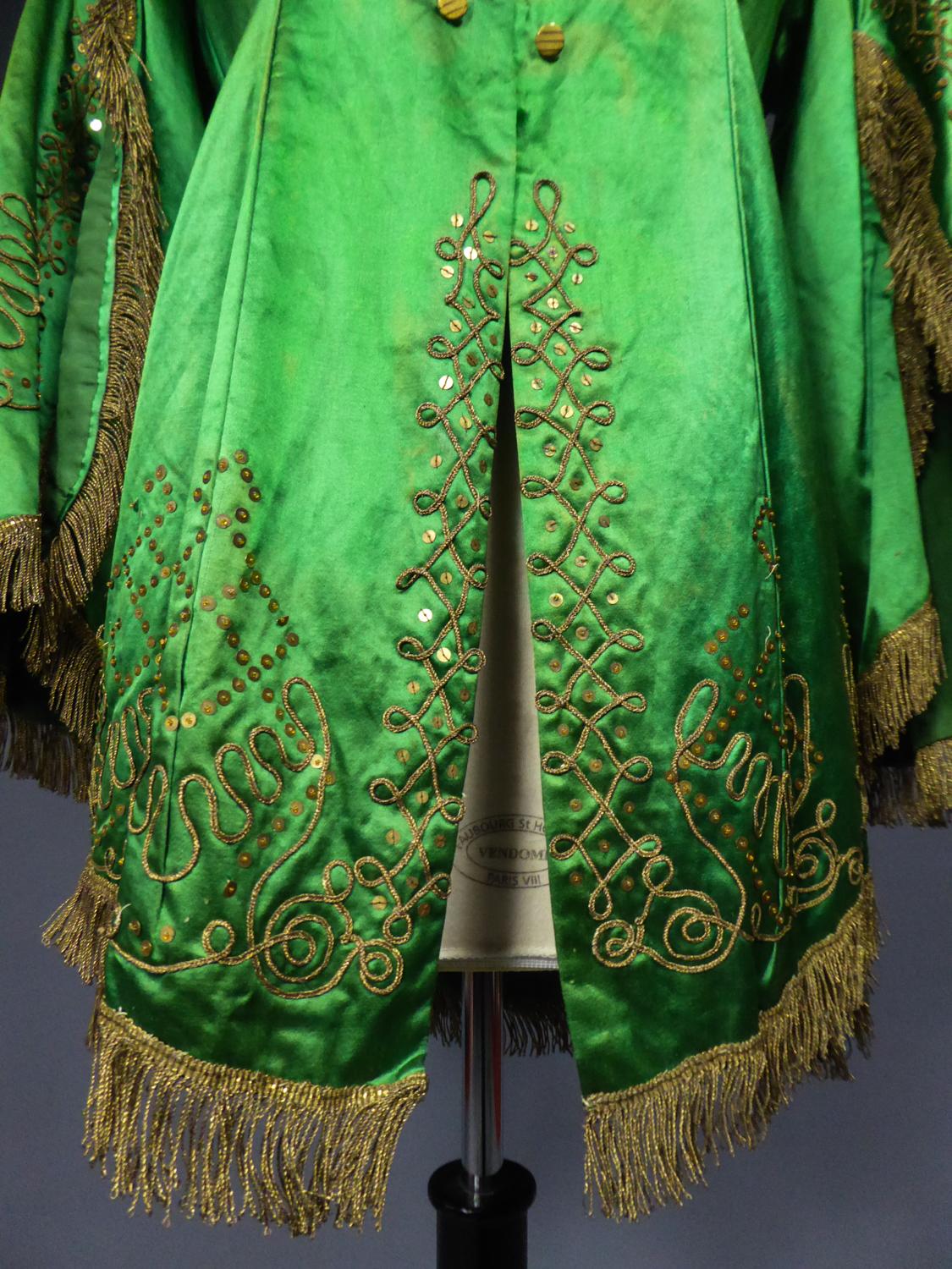 Circa 1940
France

Beautiful orientalist Fancy evening jacket or costume dating from the 1940s / 1950s. Yellow-green silk satin embroidered with golden sequins and appliqués of cords in golden threads. Fringes on the edge in trimmings of golden