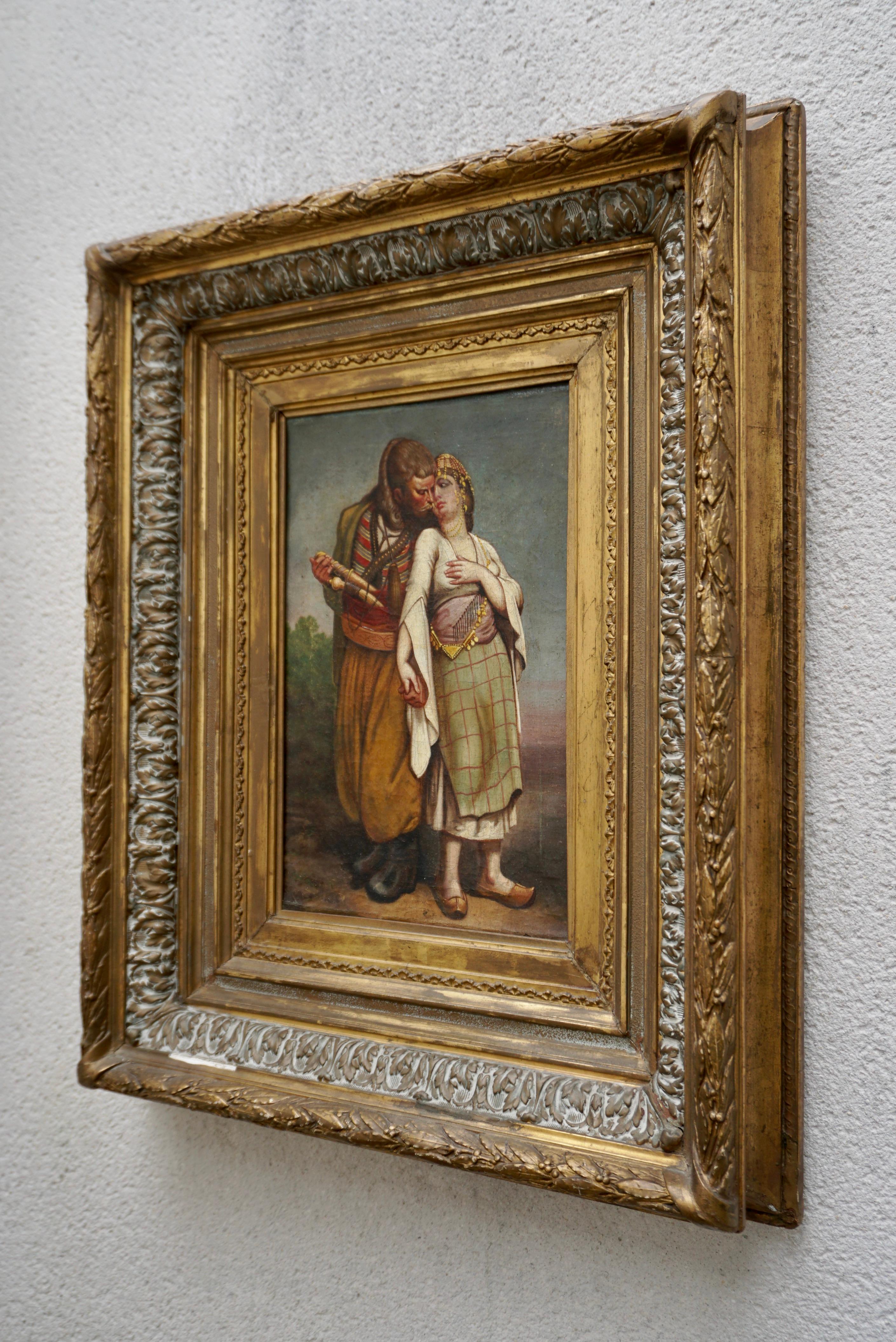 Orientalist oil painting of a romantic scene.Late 19th Century  

Man and beautiful young woman in their marriage engagement, Nusayriyah Mountains. Syria, Middle East. 

Panel: Height 35 cm, width 22 cm 
Frame: Height 65 cm, width 52cm, depth 9 cm 