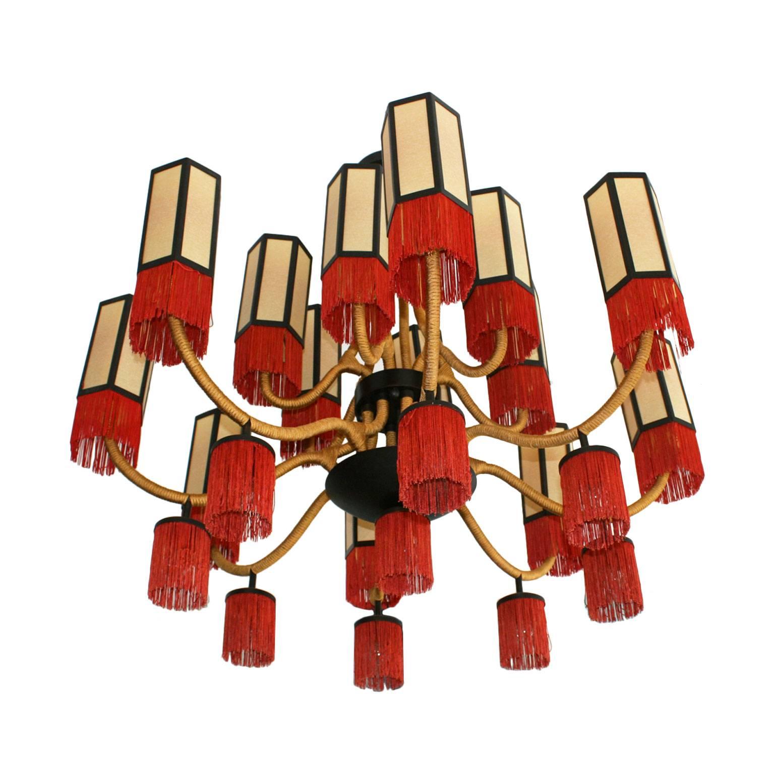 Orientalist style suspension lamp. Structure made of metal and reddish brass, coated with golden cotton cord.
Fourteen octagonal shape screens made of parchment finished in cotton fringes, France 70 years.