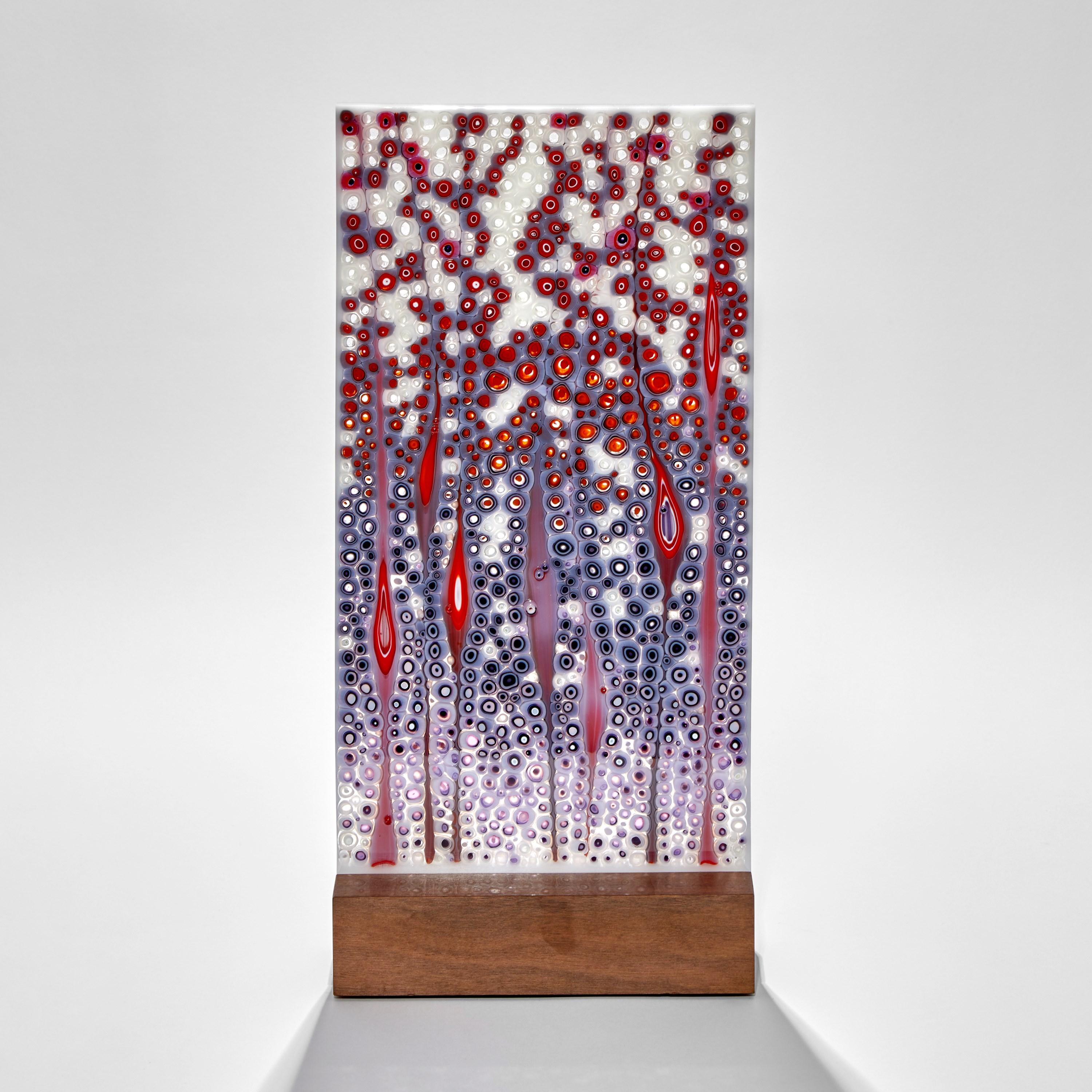 'Orientation in Red & Purple', is a unique purple, red and white glass sculpture by the Austrian artist Sandra A. Fuchs. Fuchs creates her own multicolored and complex glass canes, which are then cut to create small 'murrina'. These she composes to
