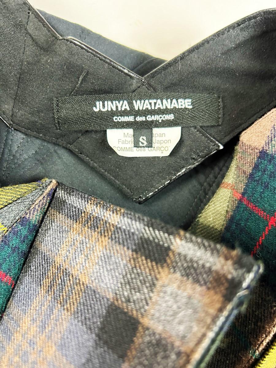 Circa 2015

Japan

Skirt and top set in the Origami style by Junya Watanabe for Comme des Garçons dating from 2010. Asymmetrical Origami top in tartan check wool patchwork with triangles lined in black stretch. Inner straps in black stretch belted