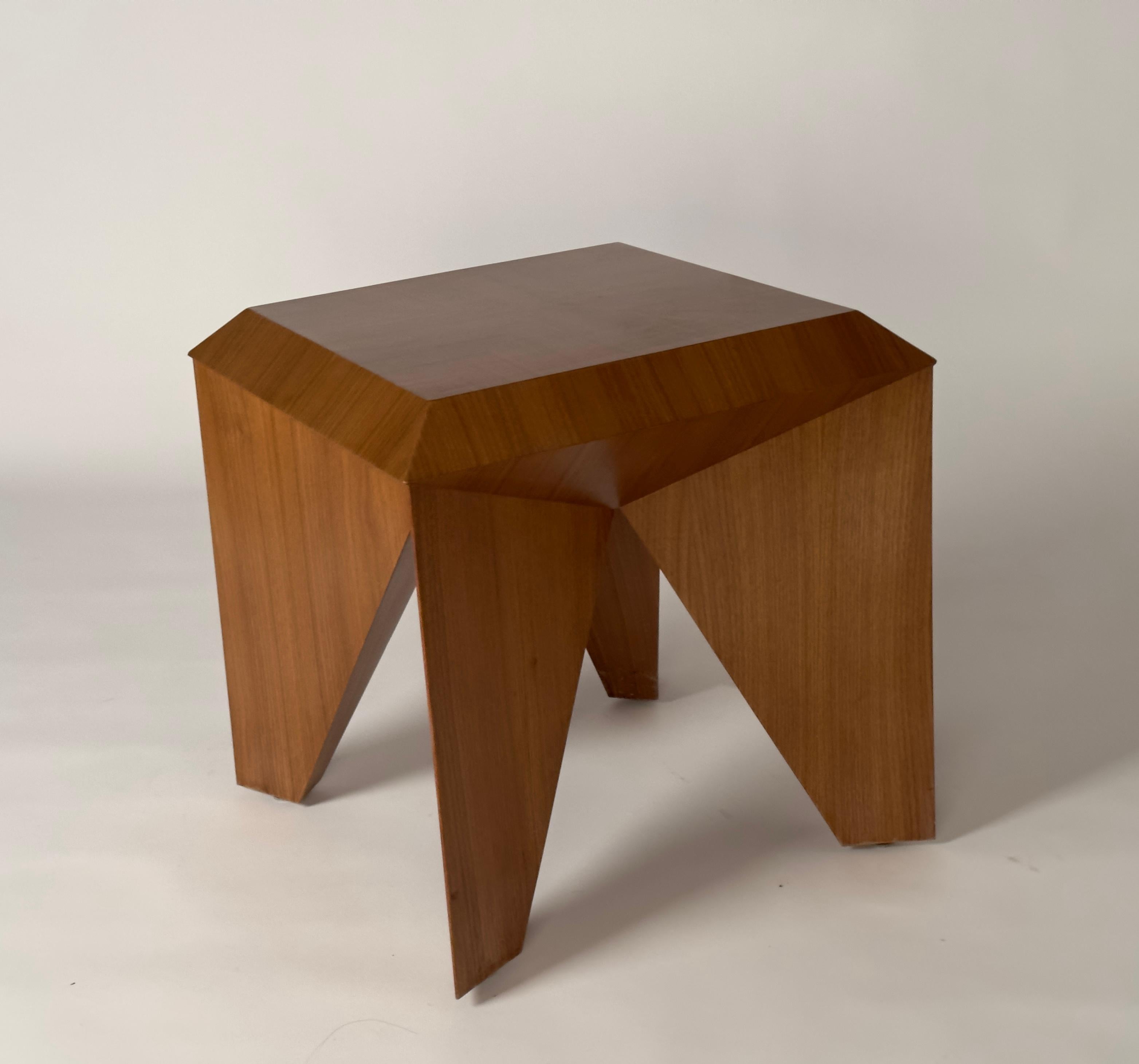 The ORIGAMI side table is an assembly of walnut veneer surfaces that fold and intersect creating an interplay of shadow and light. Designed by Hassan Abouseda for HAF. The ORIGAMI side table is customizable in different finishes and wood veneers.