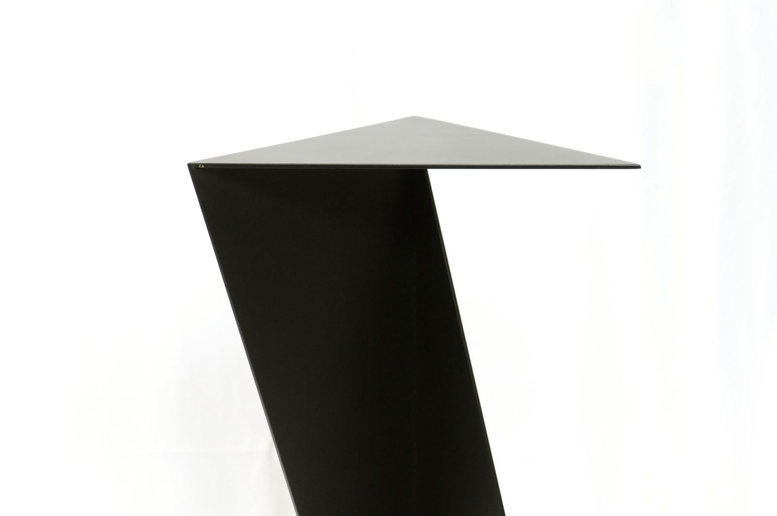 Origami style steel pedestal stand. Black finish. Dimensions: H: 36 inches: W: 17 inches: D: 8.5 inches.