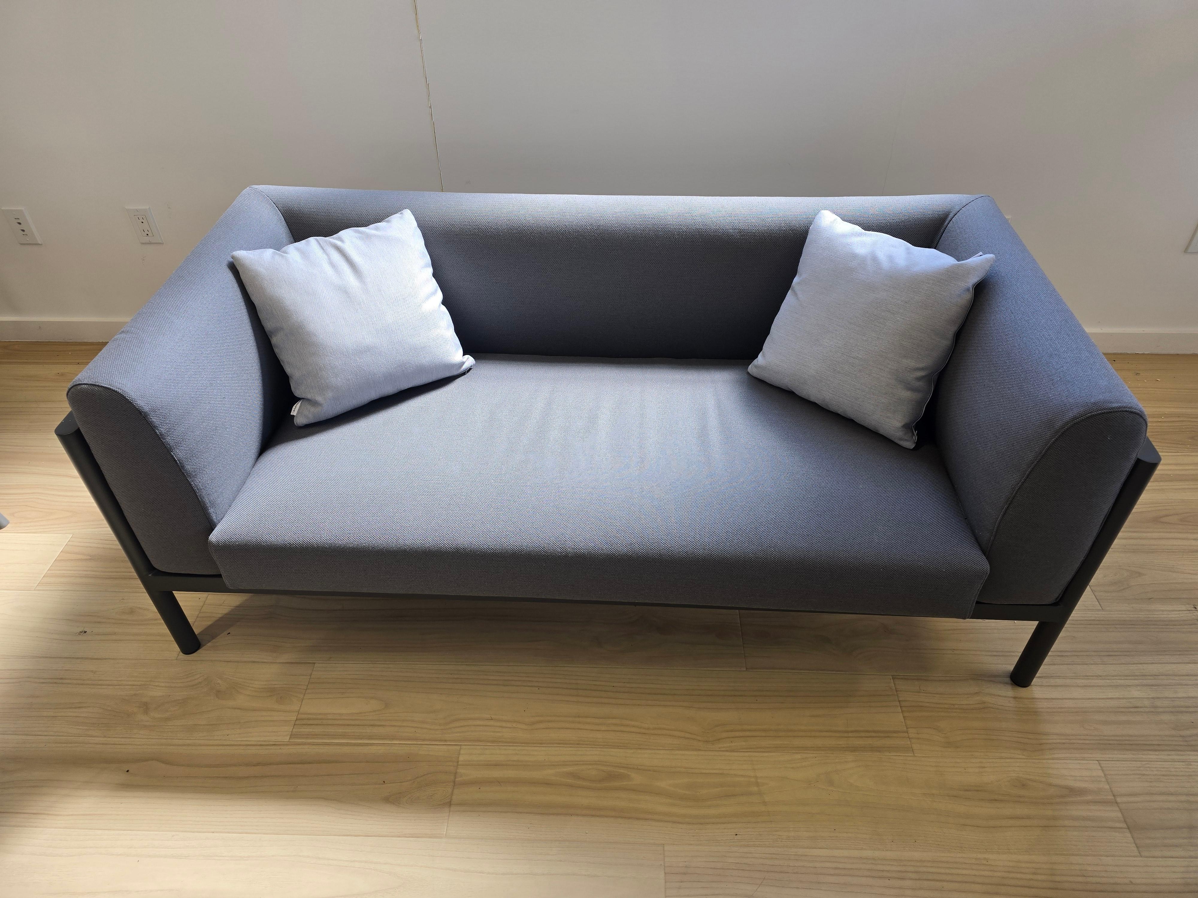 Origin 2 seater sofa. Powder coated aluminum structure available in Mineral White 34 and Grey 56. Seat and back cushion in high resistance polyurethane foam weighing 35 kg.  Manufacturer: POINT

*Showroom sample