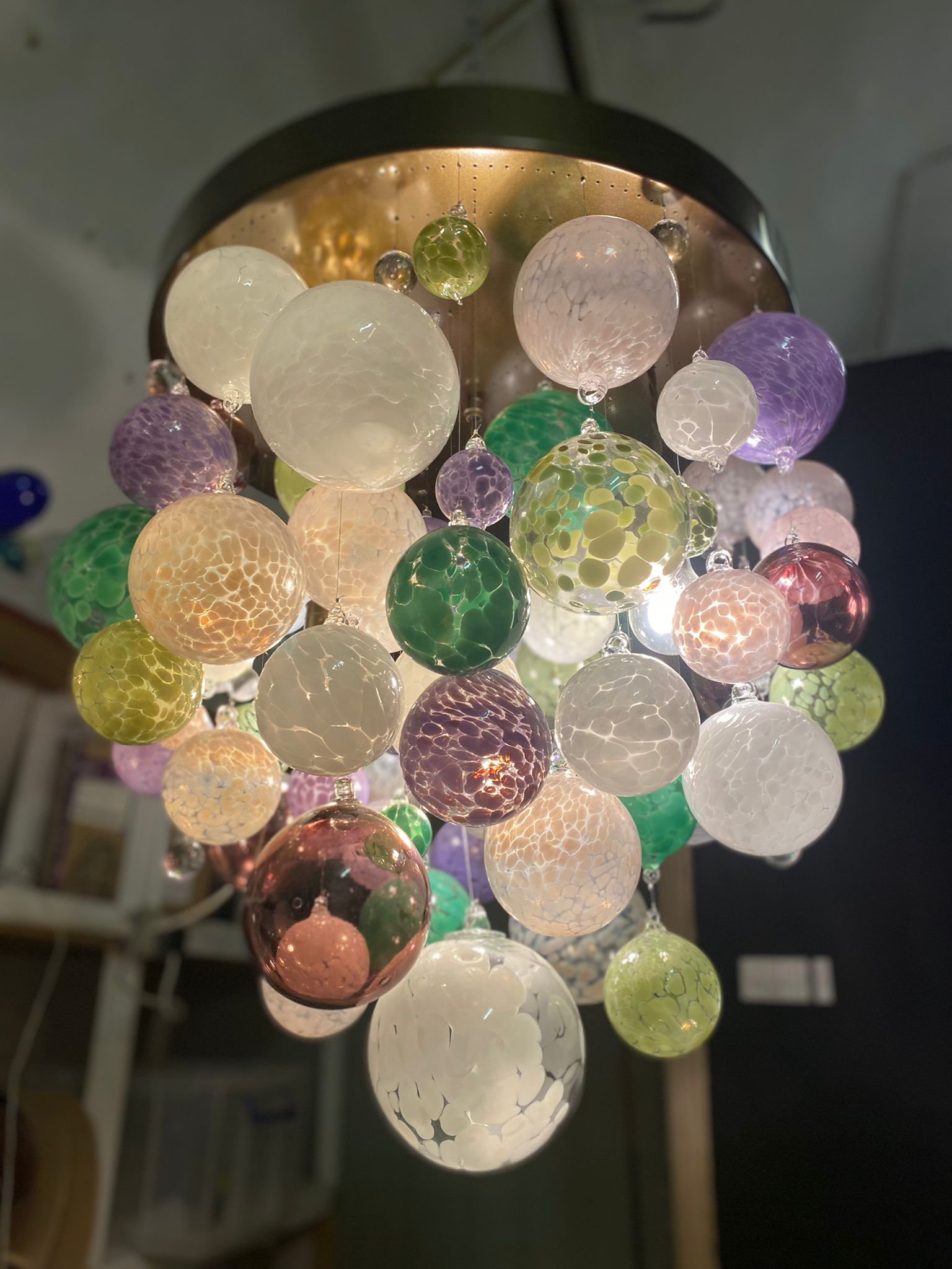 This contemporary chandelier is an origin II design and features over 50 individually blown glass spheres. The glass is blown in Europe and the UK and the chandelier is designed and handcrafted in our studio in South London. 

This chandelier is