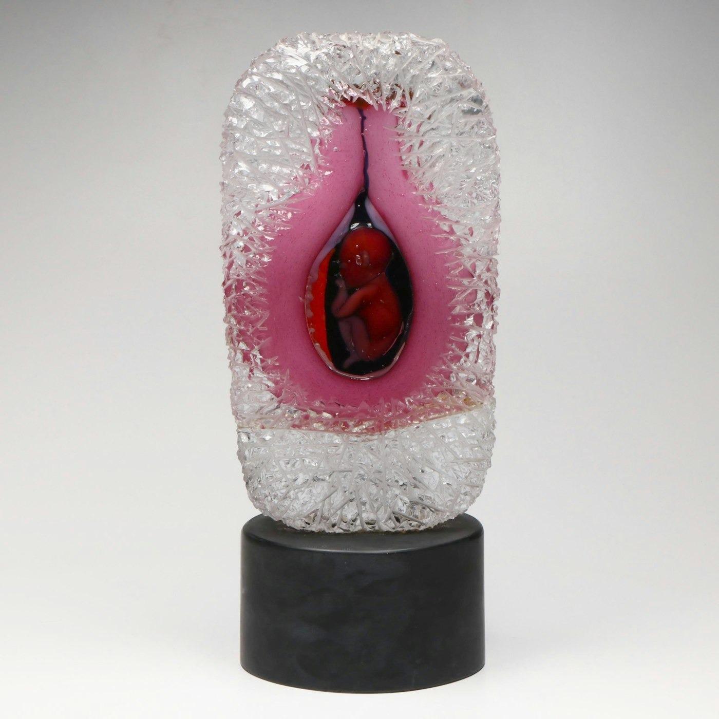 A rare and emotionally resonant glass sculpture by legendary Murano master Pino Signoretto (Italian, 1944–2017), depicting a stylized womb cradling a fetal figure. Meticulously hand-sculpted in Murano glass, this monumental piece features a layered