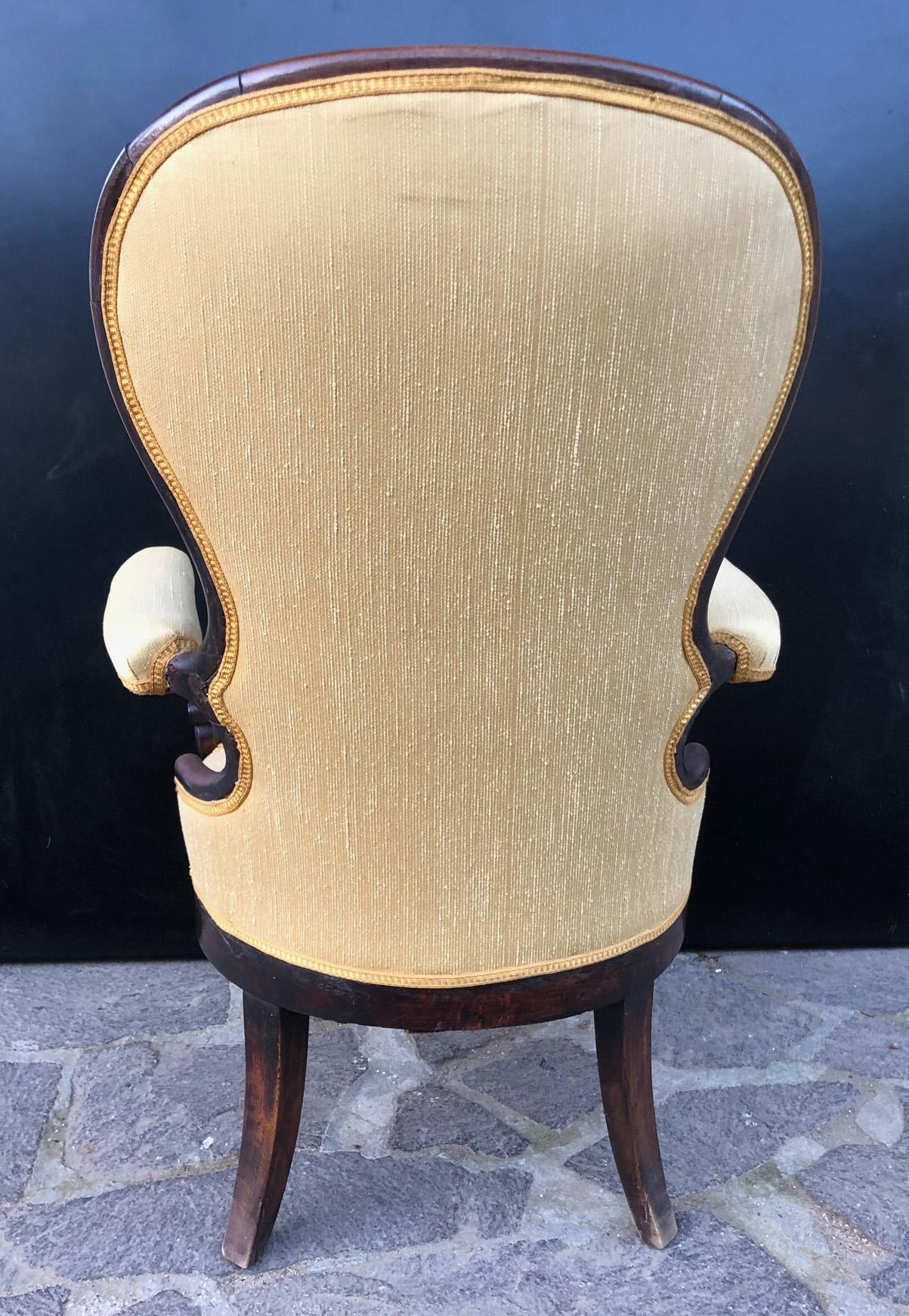 Original 1850 Italian armchair in solid walnut with new upholstery. 
The article used to be in a bedroom.
 Later it was placed at the entrance of an important house in a waiting area near the door.
It comes from an old country house in the