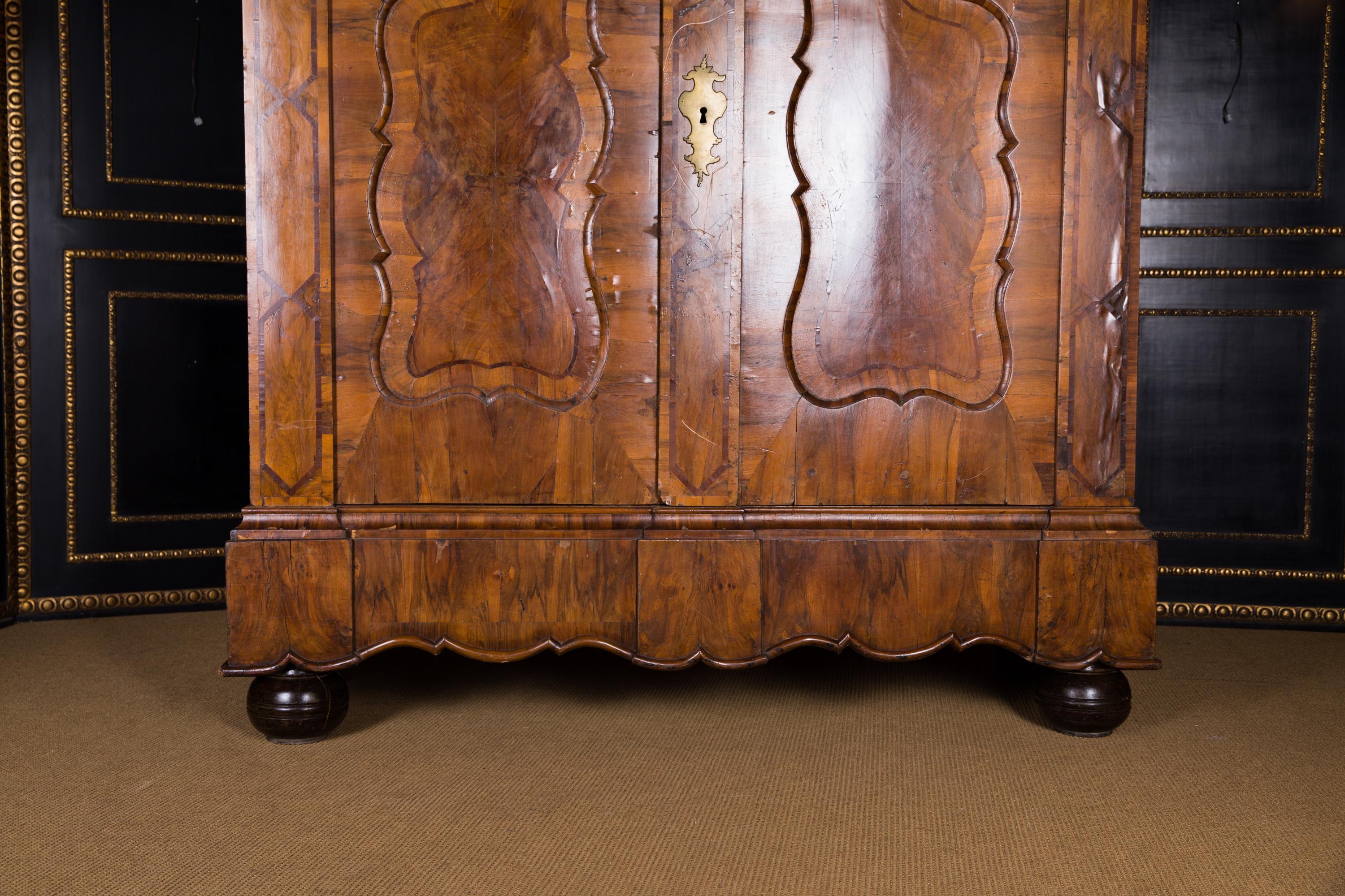 Original big baroque cabinet circa 1740 walnut

Walnut on solid wood. Rectangular body with two doors. Volute-shaped structure. Multiple cranked, profiled cornice.

Historical condition, some small veneer spots are missing and small veneer additions