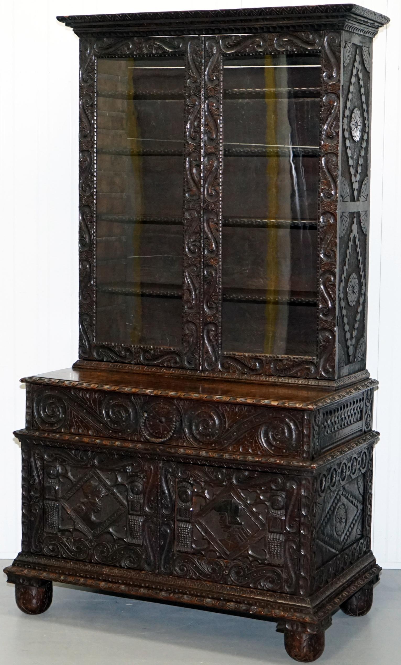 We are delighted to offer for sale this stunning handmade in England from solid English oak early 18th century circa 1740 bookcase cabinet

A very rustic early piece of English country house furniture, the carving is naive and period, each of the