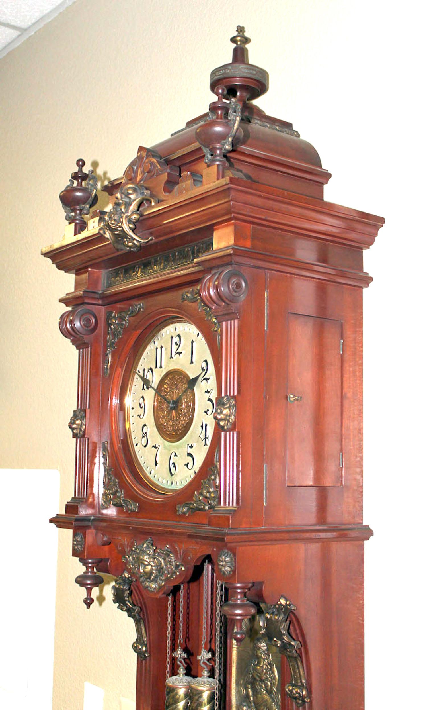 Here we are offering an extreme rare Ansonia Antique Standing floor clock that is in its original mint condition. It stands 94 inch tall. The entire case is in mahogany finish and highly decorated with brass trimmings. It has an 8 day double weight