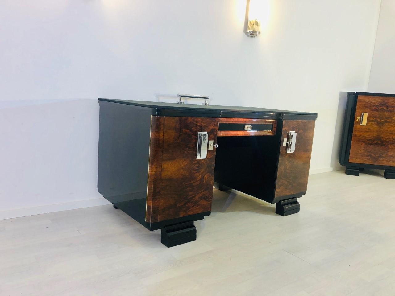 Amazing original Art Deco desk from the glamourous 1920s made of walnut wood. This one of a kind French masterpiece convinces with its perfect, restored condition and with its doors made of beautiful walnut burl. The desktop got covered with a