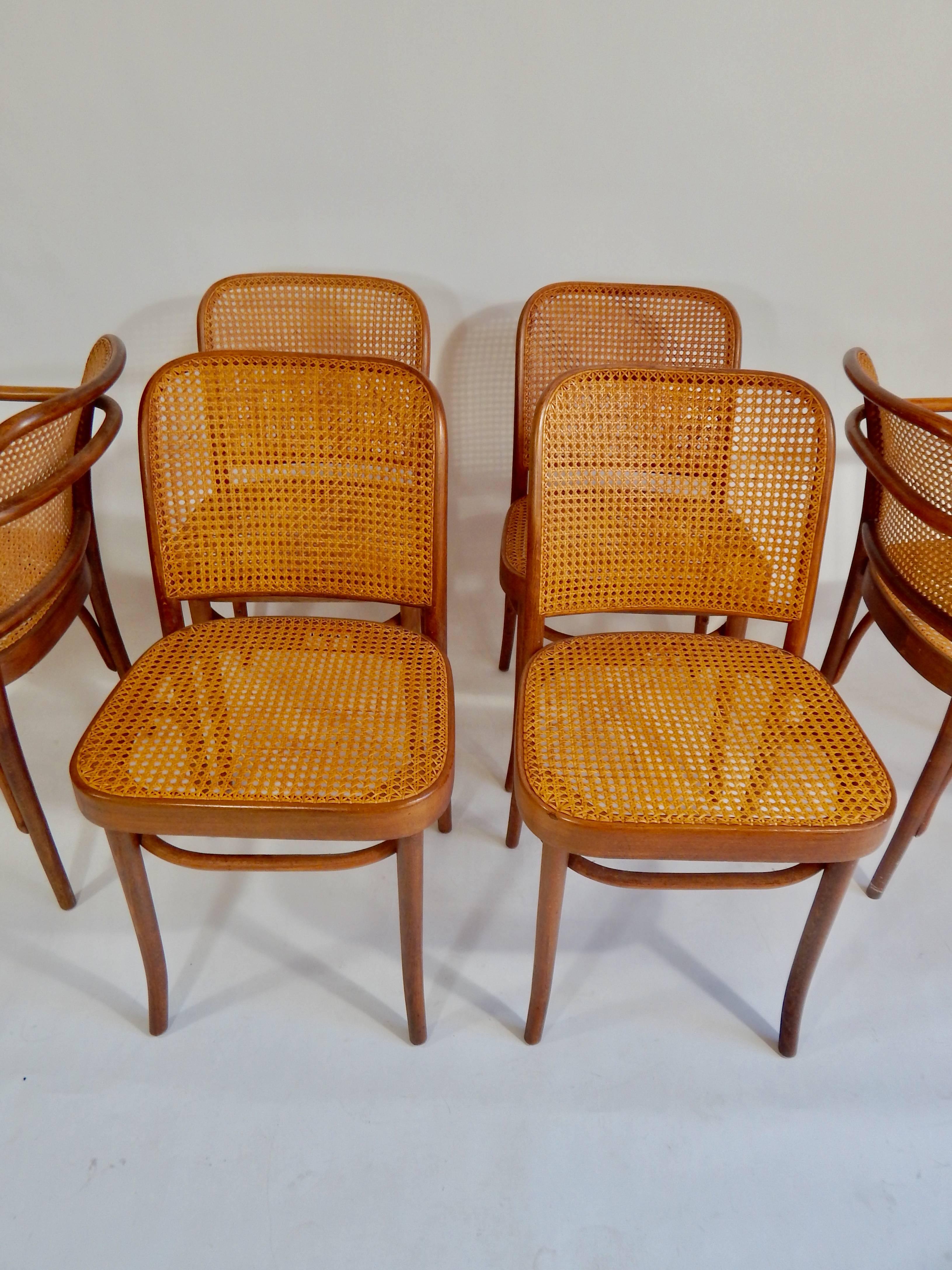 The original 1920s version of these Josef Hoffman for Thonet designed chairs. Four side chairs and two armchairs. All are marked Thonet and made in Poland. Bentwood and cane. All hand caning. Entire set is in exceptional original