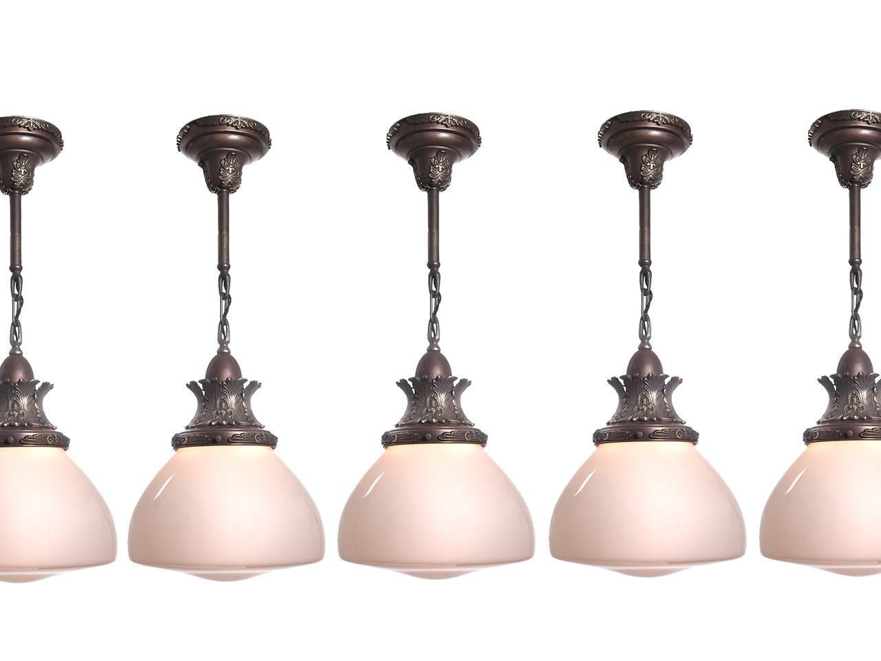 These globes and fixtures are really nice originals and we have a good collection of them. The closed bell shaped domes are very unique and the tops have a rich two-tone cast crown and matching canopy. We priced these per lamo so you can buy just