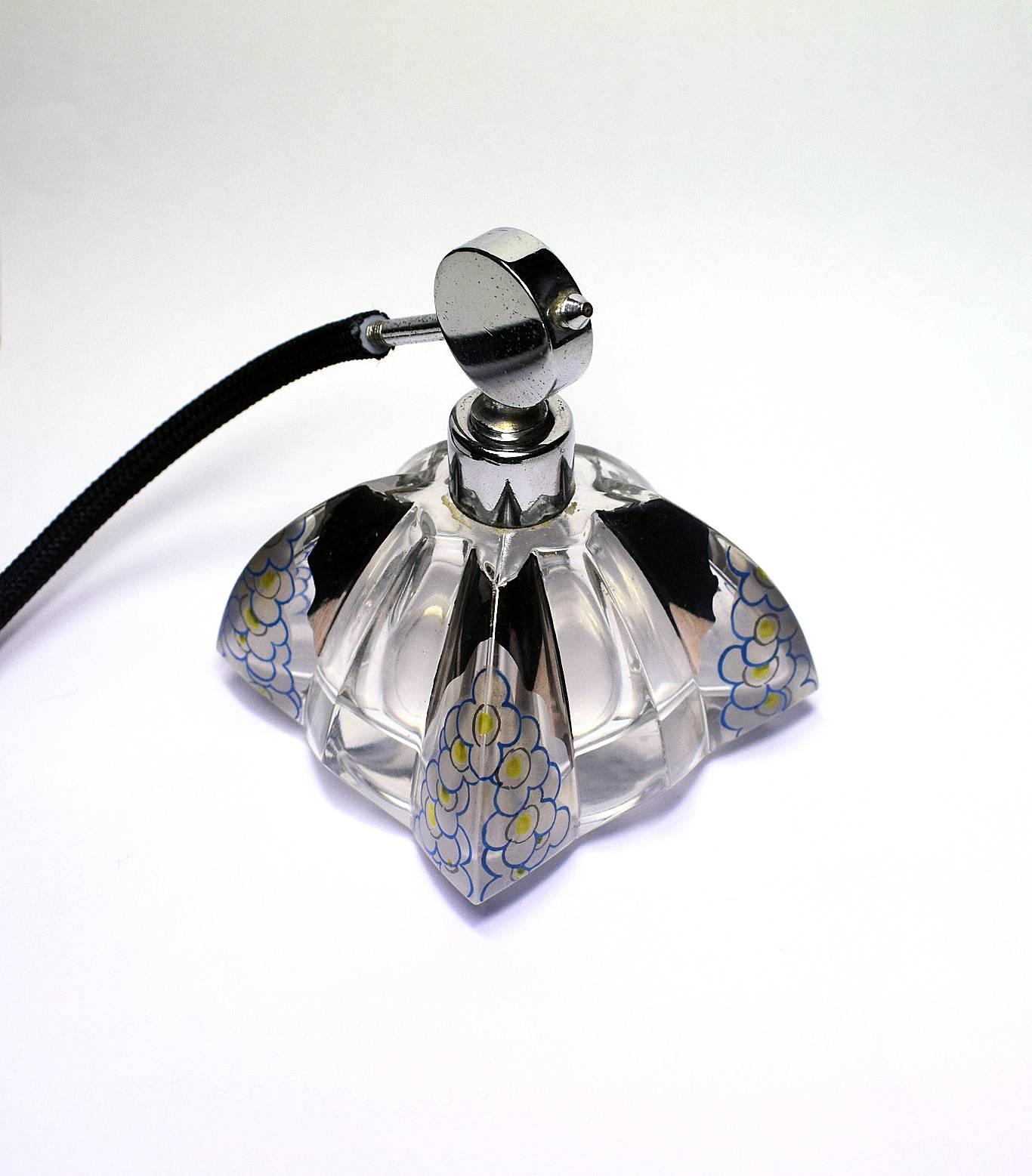 A beautiful blue, 1930s chrome top blue glass scent bottle cut which is decorated with molded floral brackets as floral friezes. Bulb and tassel are present. Overall condition is excellent, very minor signs of age with no damage anywhere.