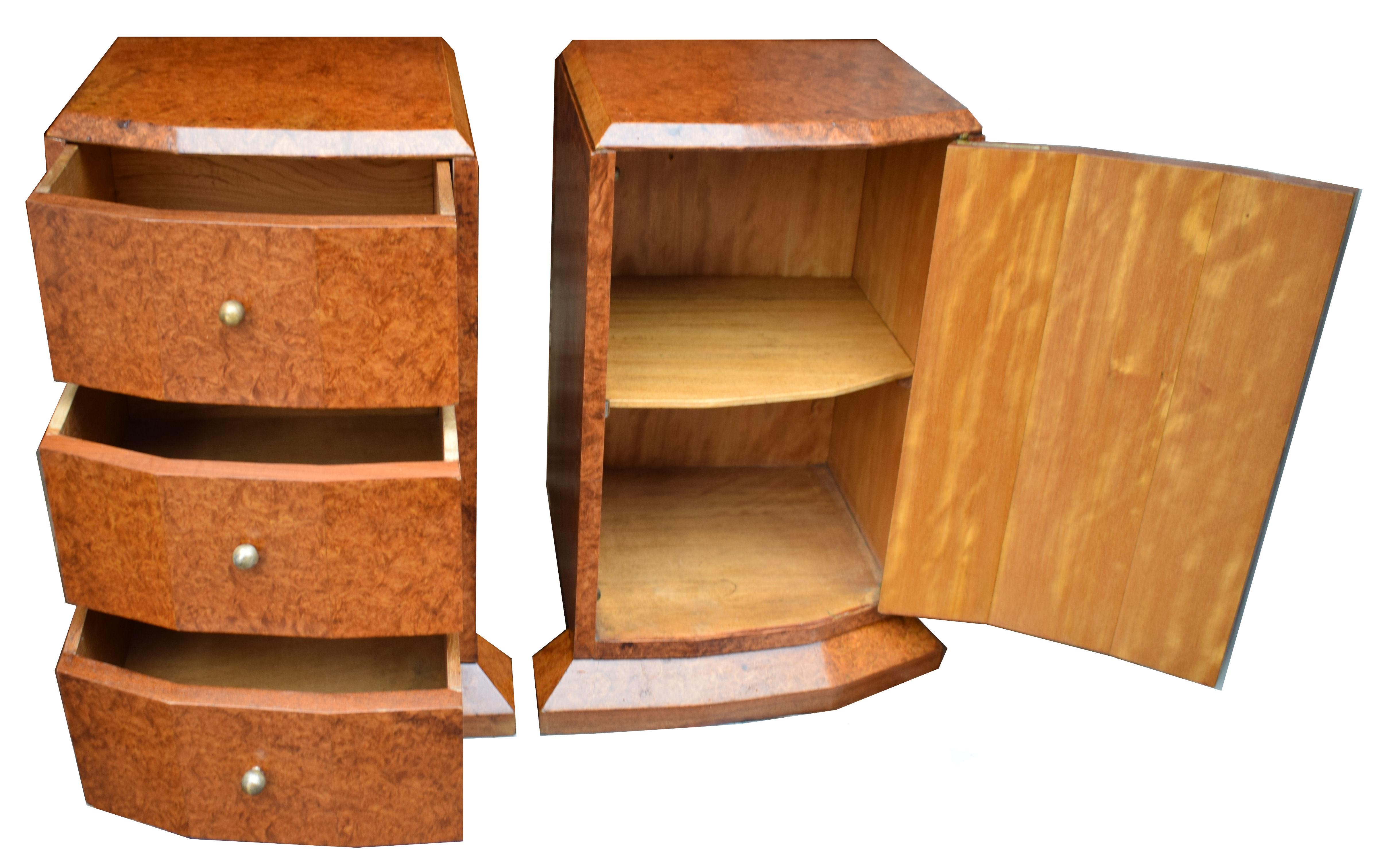 Fabulous pair of matching 1930s Art Deco bedside tables in heavily figured walnut veneers. His and hers bedside tables with one cabinet which has fake frontage drawers opening to reveal a generously sized shelved cupboard and the second cabinet is