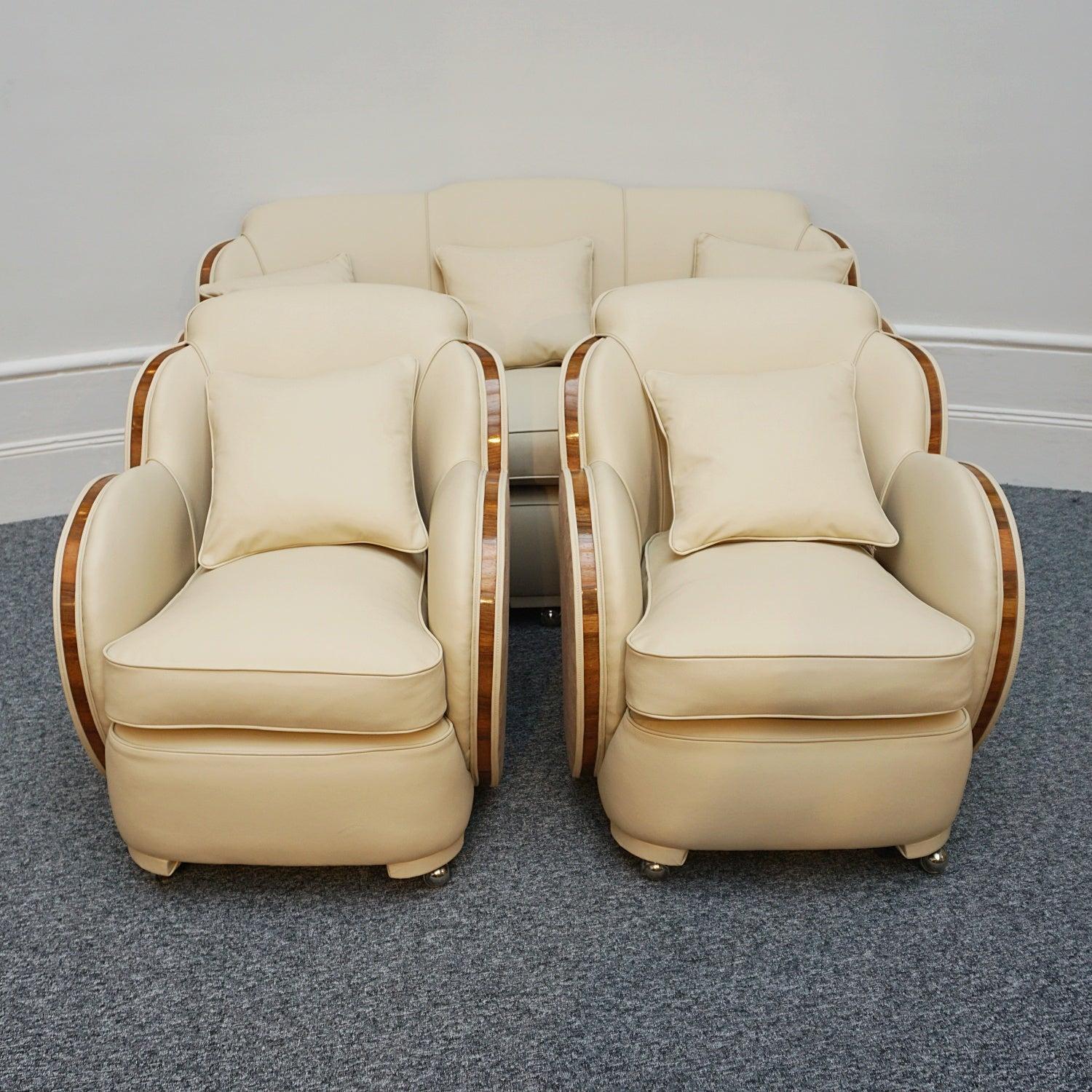 An Art Deco 'Cloud' three piece lounge suite by Harry & Lou Epstein. Three seater cloud back sofa and two armchairs. Figured walnut show wood banding. Re-upholstered in cream leather and contrasting faux suede. 

Dimensions: Sofa: H 84cm, W 167cm