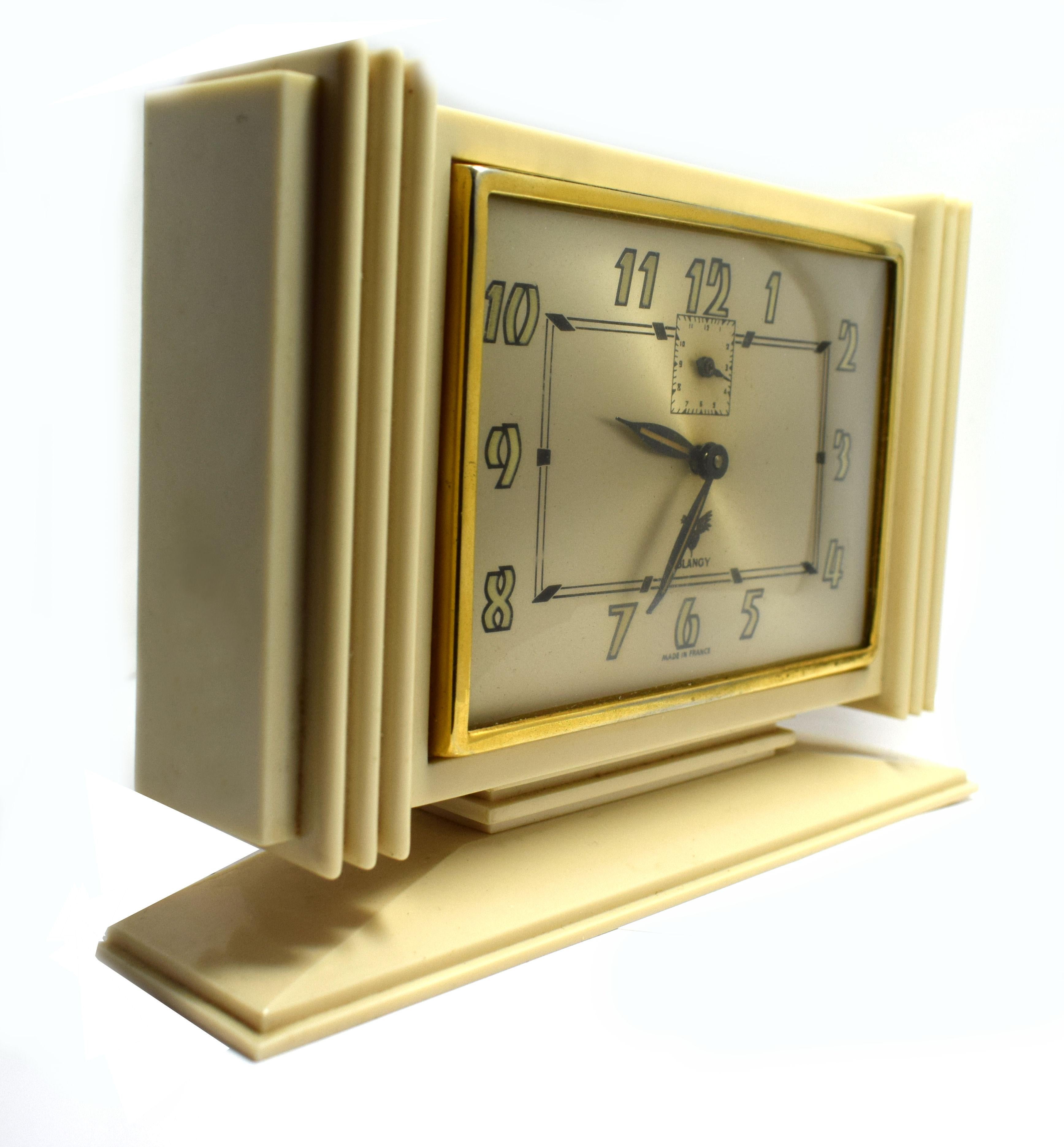 Original 1930s French Art Deco clock made by Blangy. Beautiful ivory colored Bakelite case with heavy Deco styling. A lovely Art Deco dial with brass bezel and very Deco numerals. Ideal size for mantle or desk /table areas. A rare find in excellent
