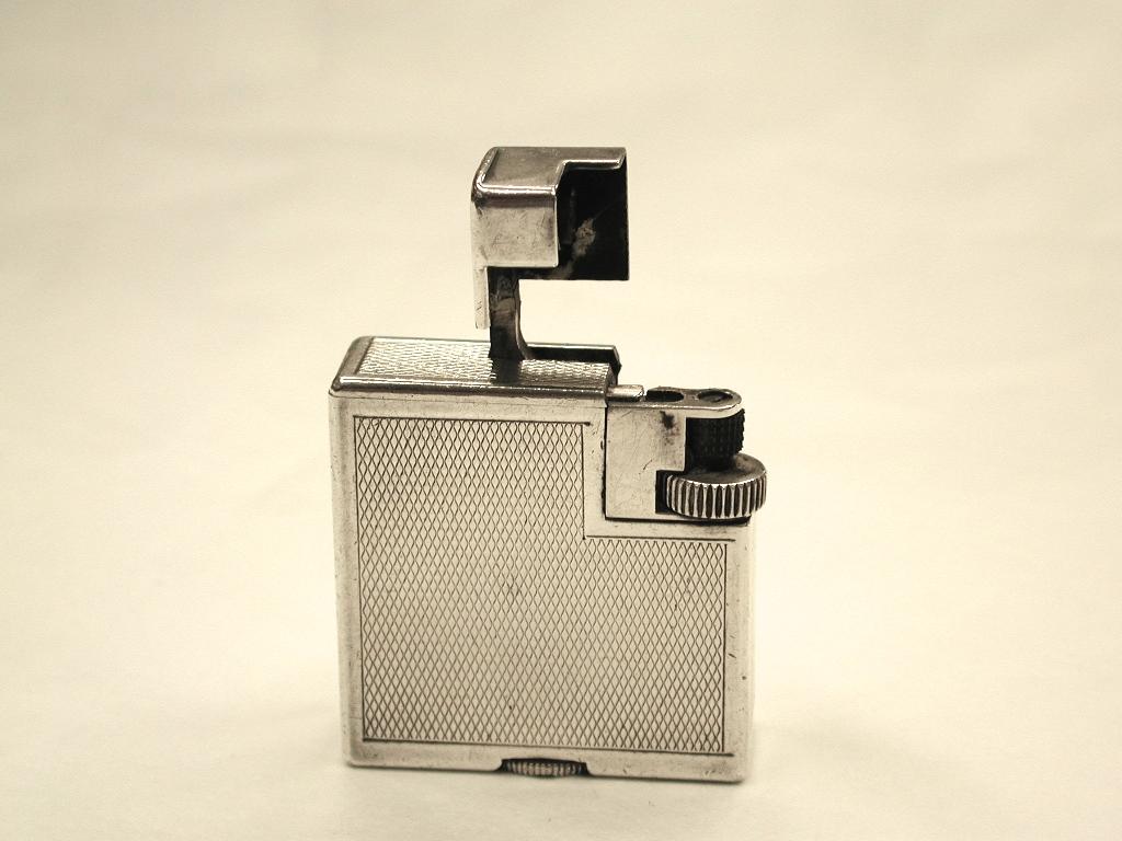 Original 1930s silver plated Dunhill cigarette lighter, made in Switzerland.
This lighter is in very good condition and in full working order.
It has a sliding flint chamber at the top, when you press the groove in at the top.
It lights with one